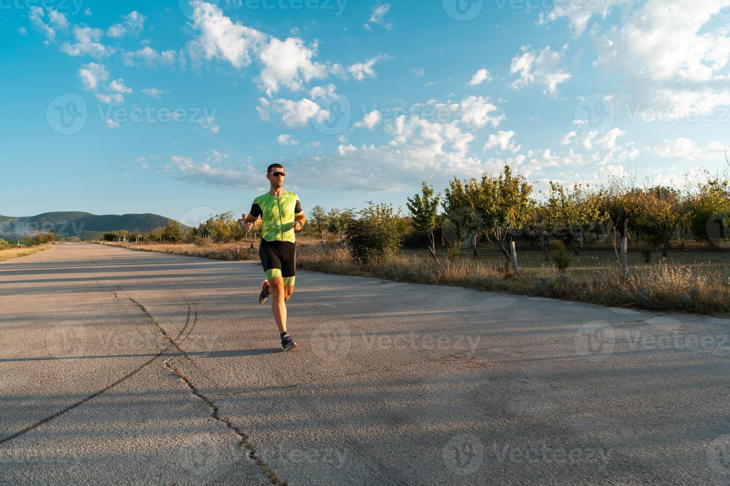 Triathlete in professional gear running early in the morning, preparing for a marathon, dedication to sport and readiness to take on the challenges of a marathon. photo
