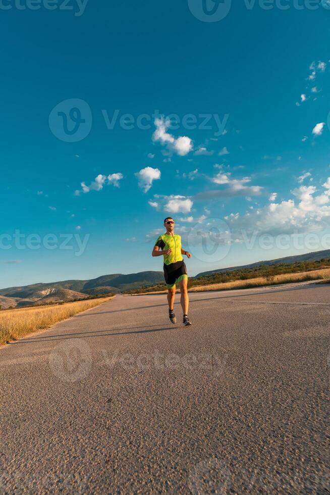 Triathlete in professional gear running early in the morning, preparing for a marathon, dedication to sport and readiness to take on the challenges of a marathon. photo