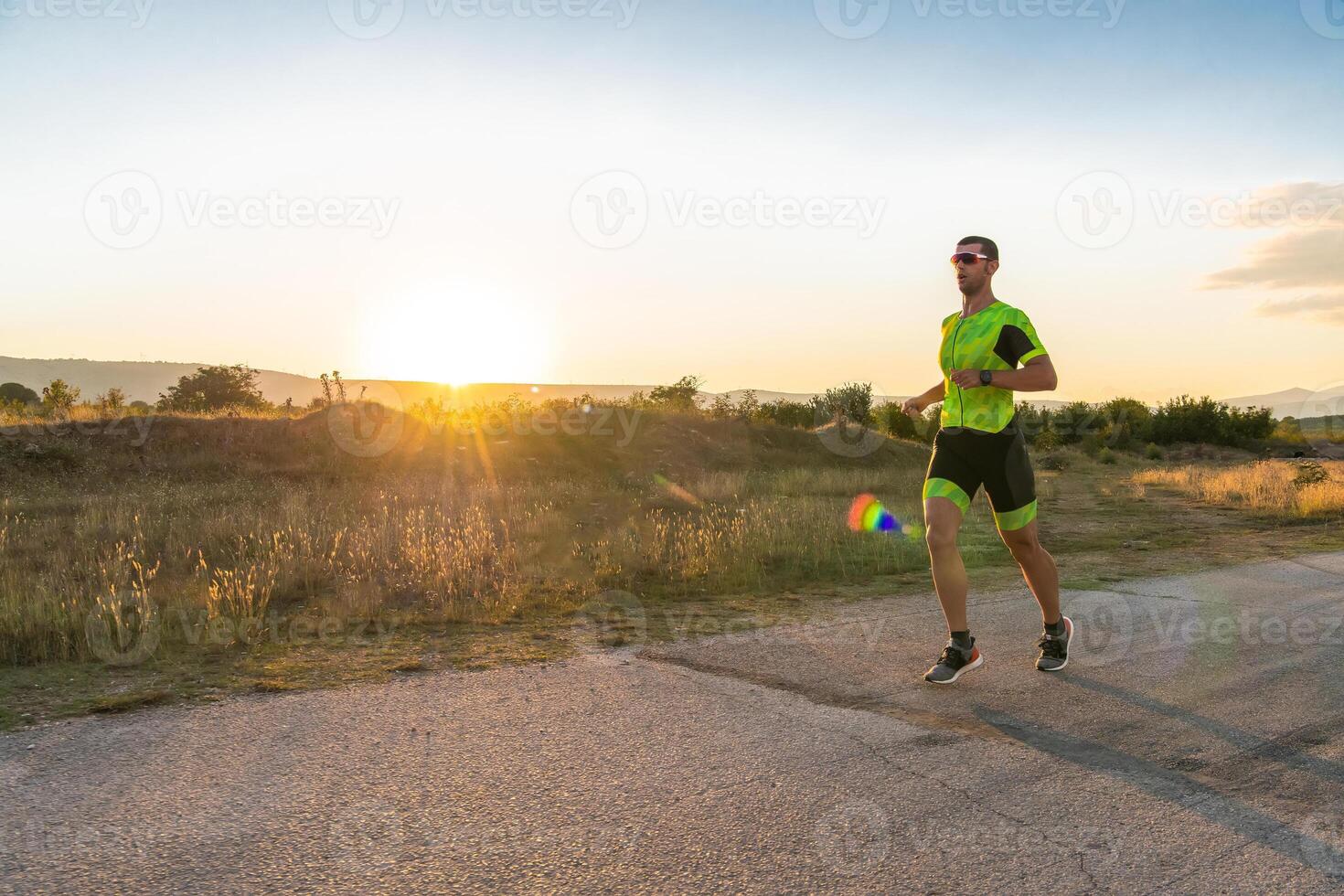 Triathlete in professional gear running early in the morning, preparing for a marathon, dedication to sport and readiness to take on the challenges of a marathon. photo
