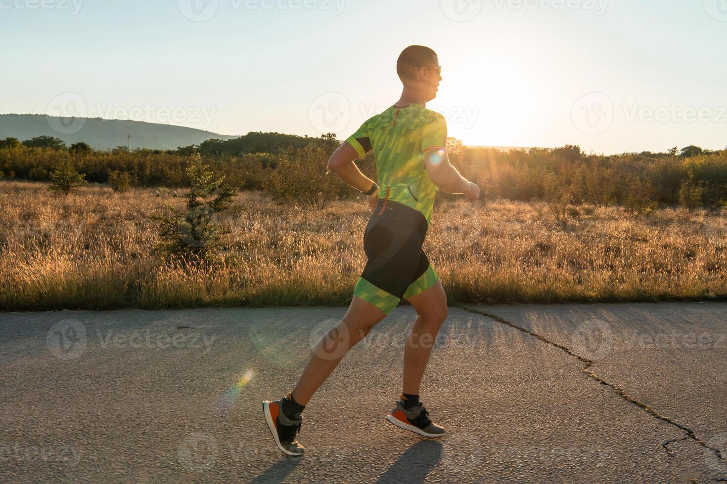 Triathlete in professional gear running early in the morning, preparing for a marathon, dedication to sport and readiness to take on the challenges of a marathon. photo