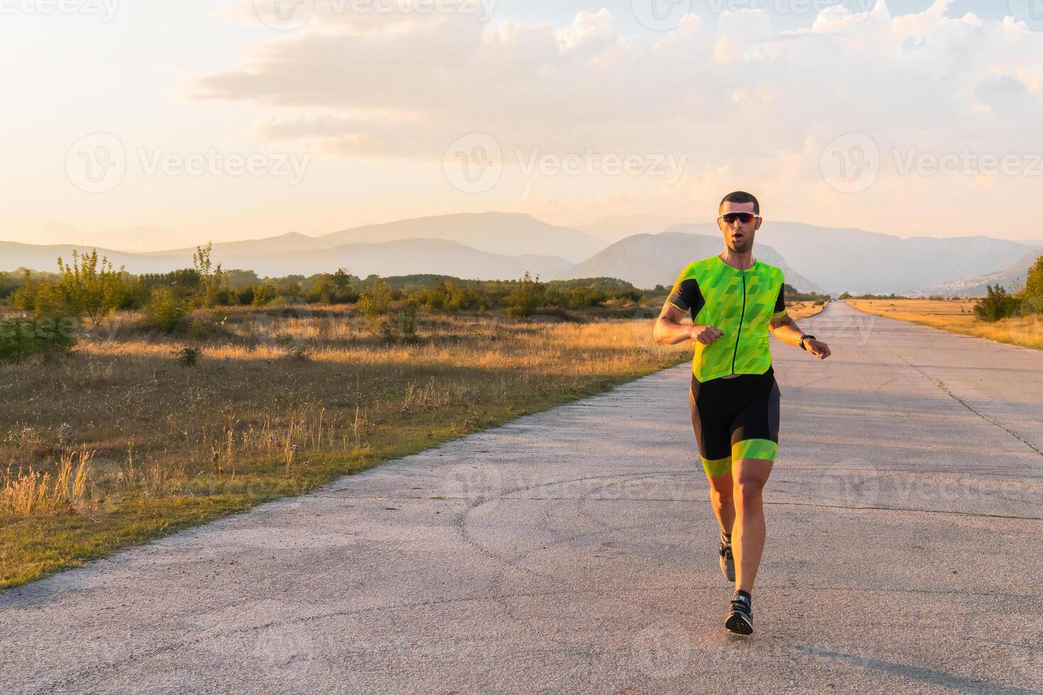 Triathlete in professional gear running early in the morning, preparing for a marathon, dedication to sport and readiness to take on the challenges of a marathon. photo