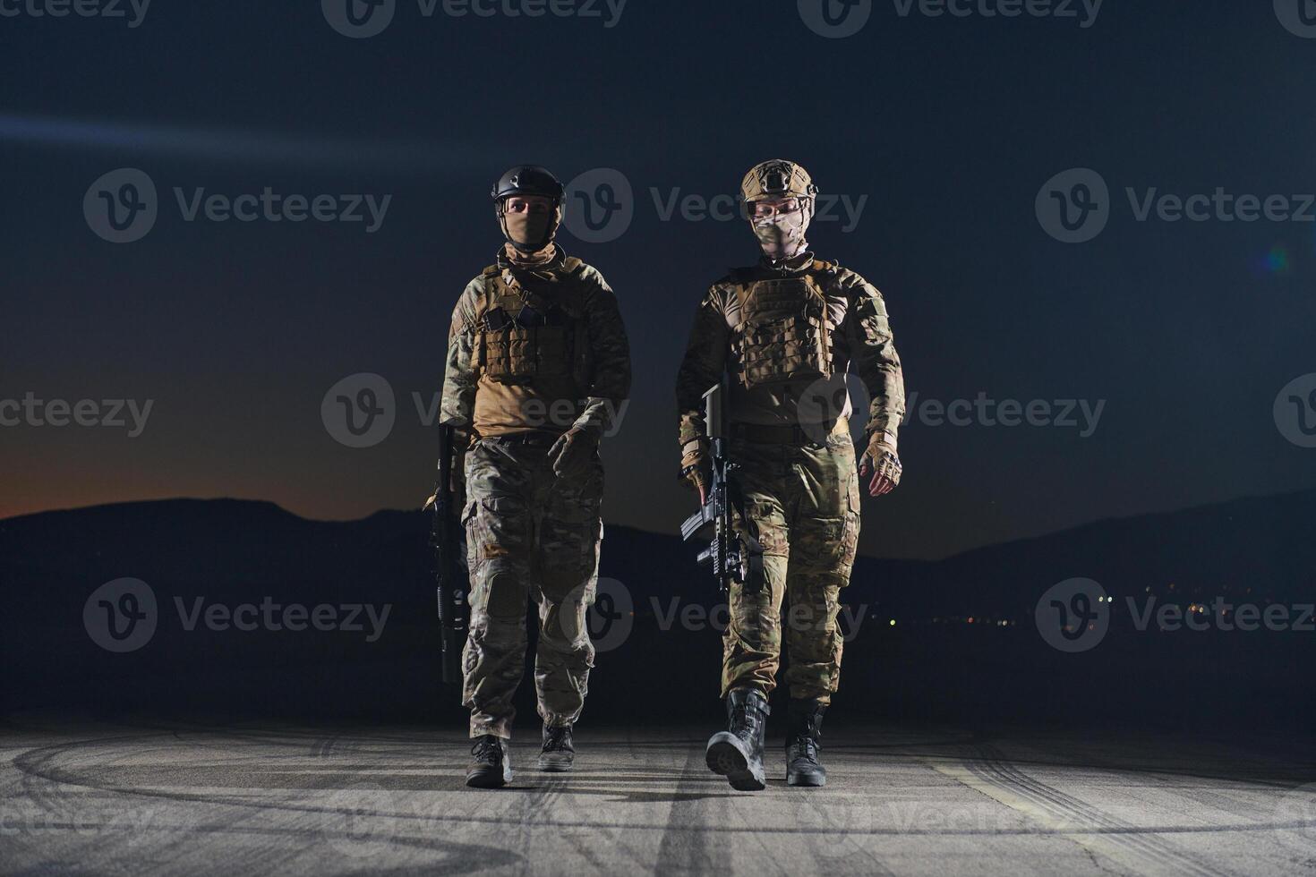 Two professional soldiers marching through the dark of night on a dangerous mission, epitomizing their unwavering bravery, unwavering teamwork, and the high-stakes intensity of their specialized photo