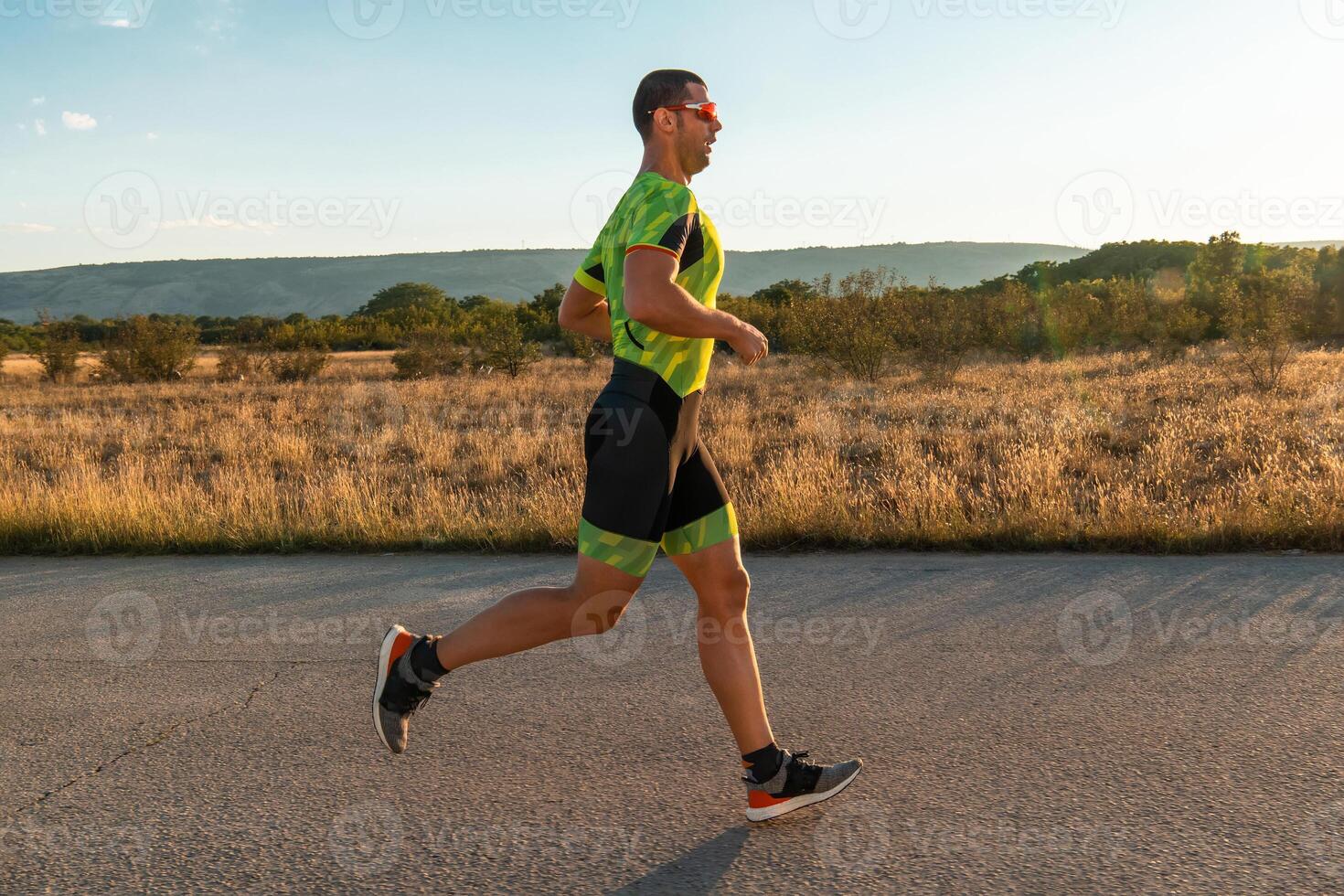 Triathlete in professional gear running early in the morning, preparing for a marathon, dedication to sport and readiness to take on the challenges of a marathon. photo