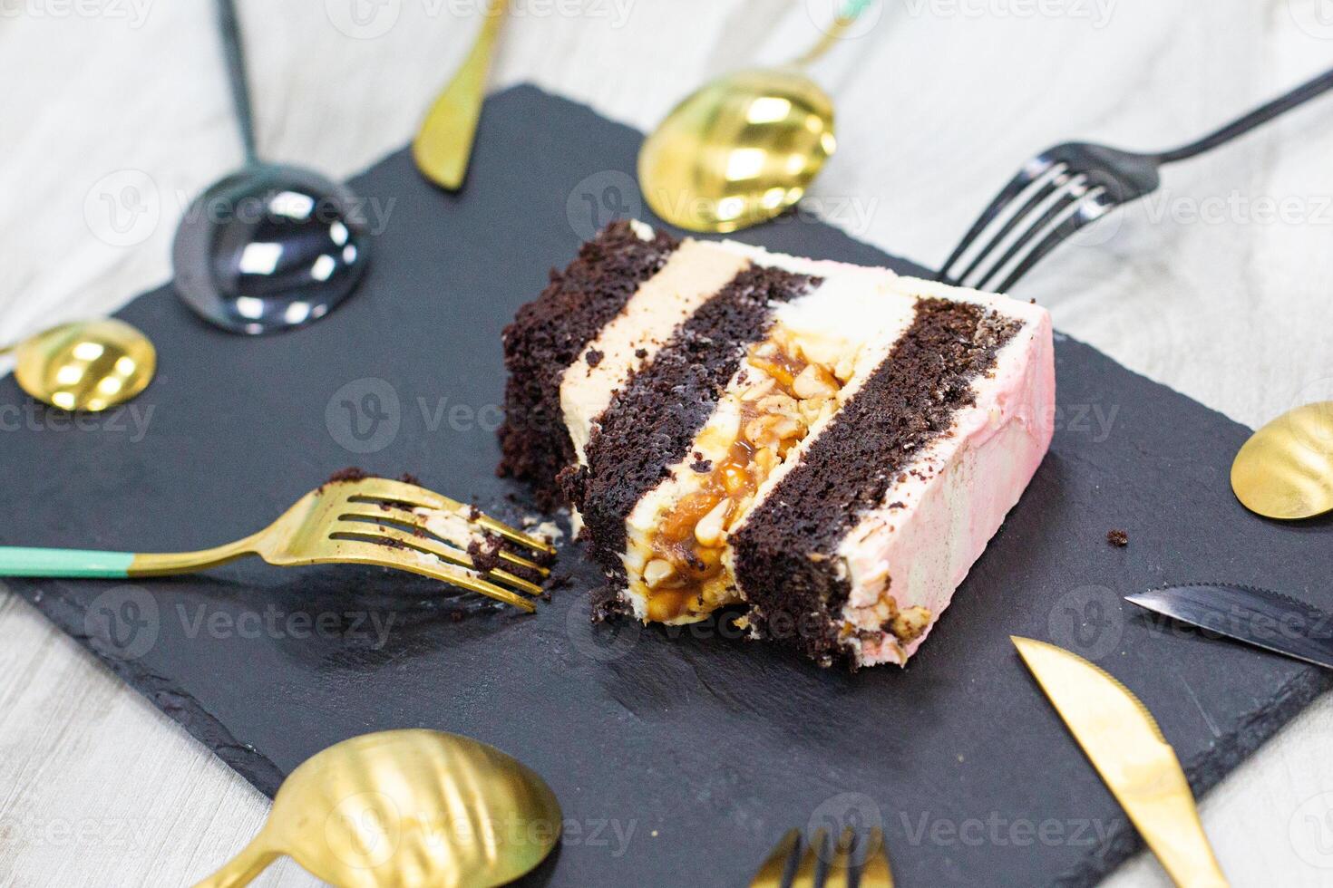 piece of cake on a plate and a lot of spoons around photo