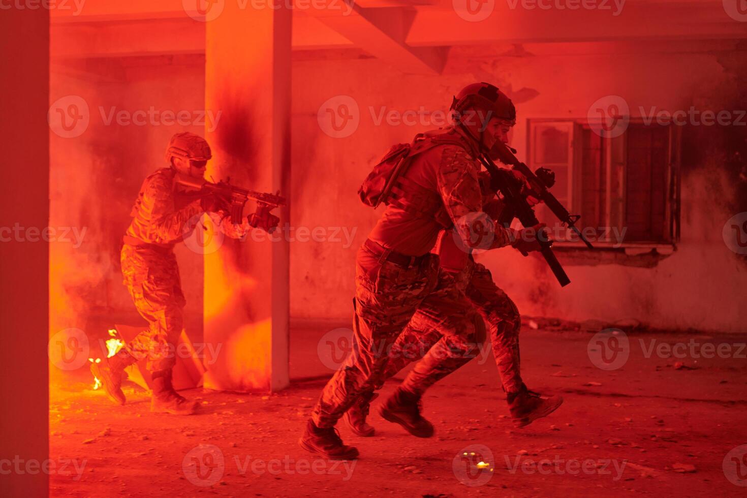 A group of professional soldiers bravely executes a dangerous rescue mission, surrounded by fire in a perilous building. photo