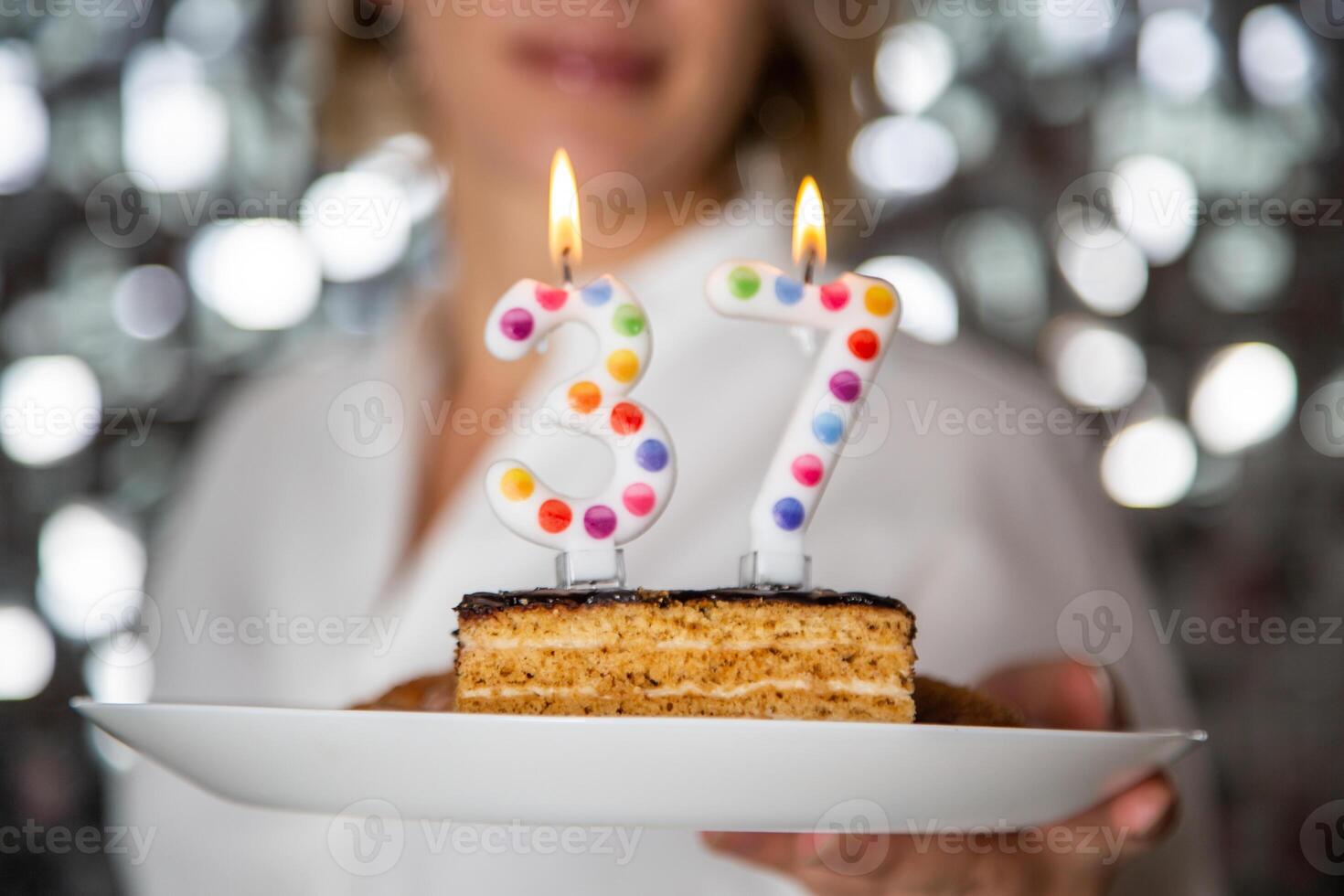 Young woman blowing candles on birthday cake, 37 photo