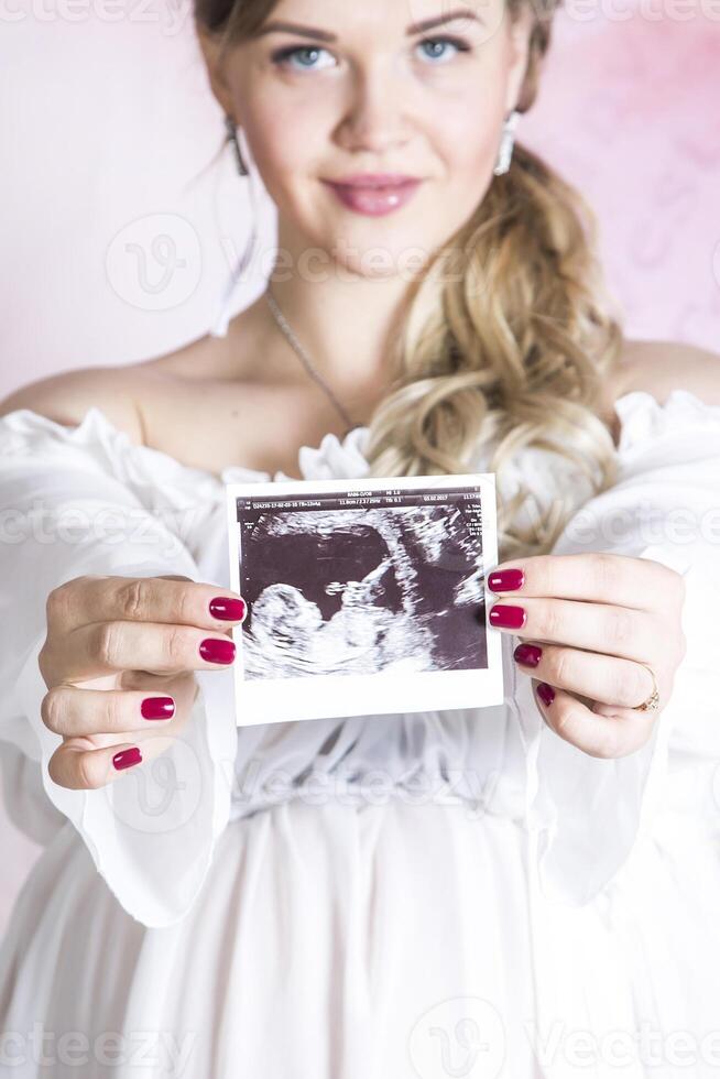 Portrait of young happy pregnant woman photo