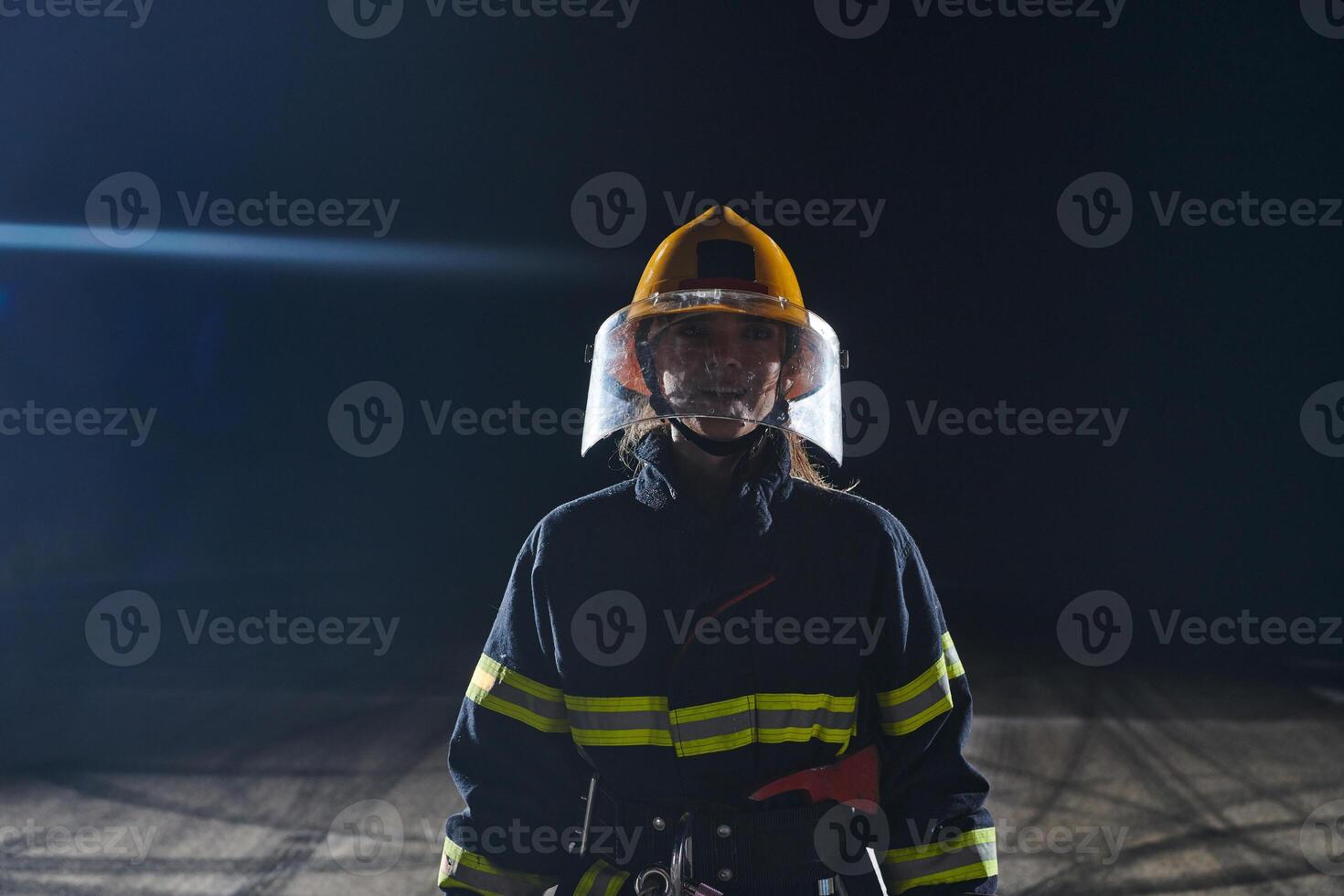 Portrait of a female firefighter standing and walking brave and optimistic photo