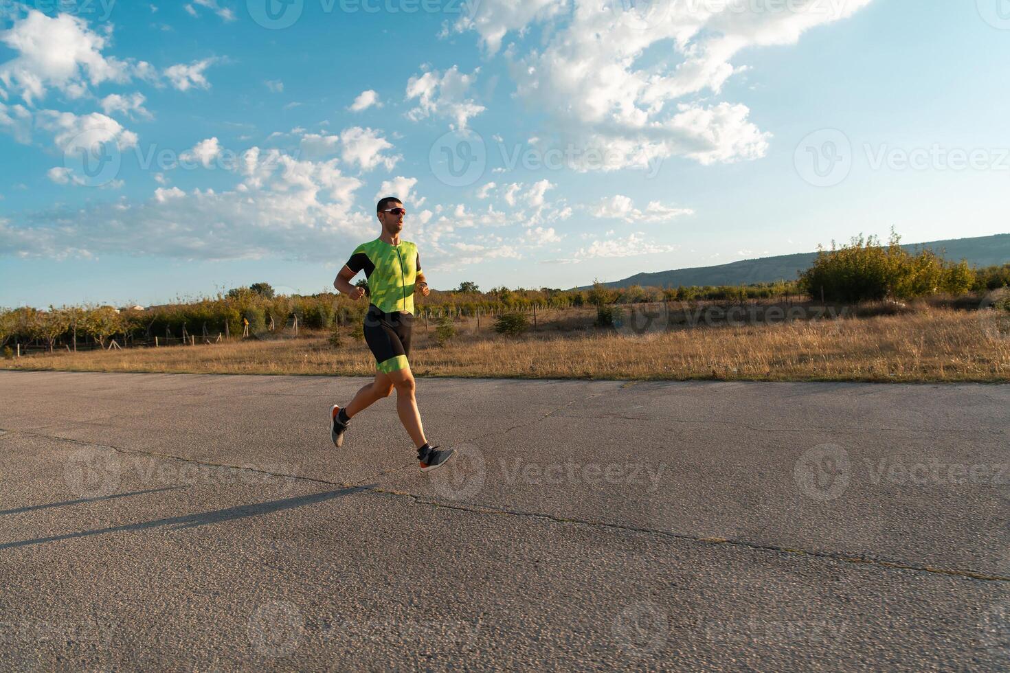 Triathlete in professional gear running early in the morning, preparing for a marathon, dedication to sport and readiness to take on the challenges of a marathon. photo