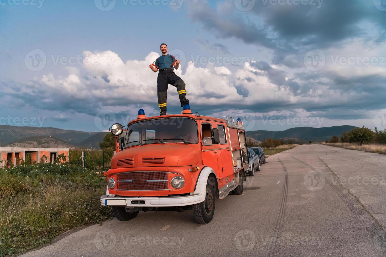 The firefighter standing confidently on the fire truck, ready to respond to any emergency. photo
