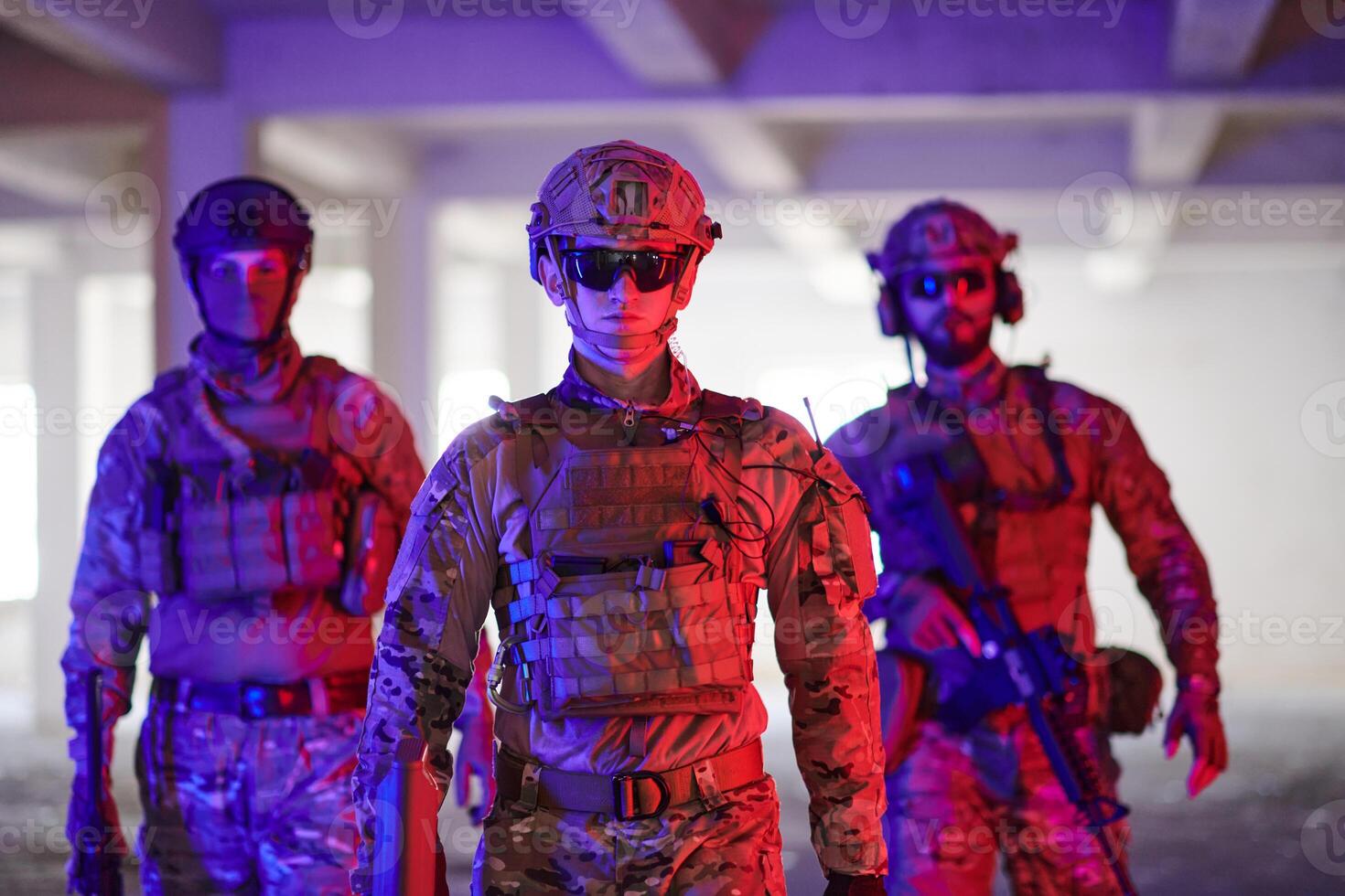 Soldier squad team walking in urban environment colored lightis photo
