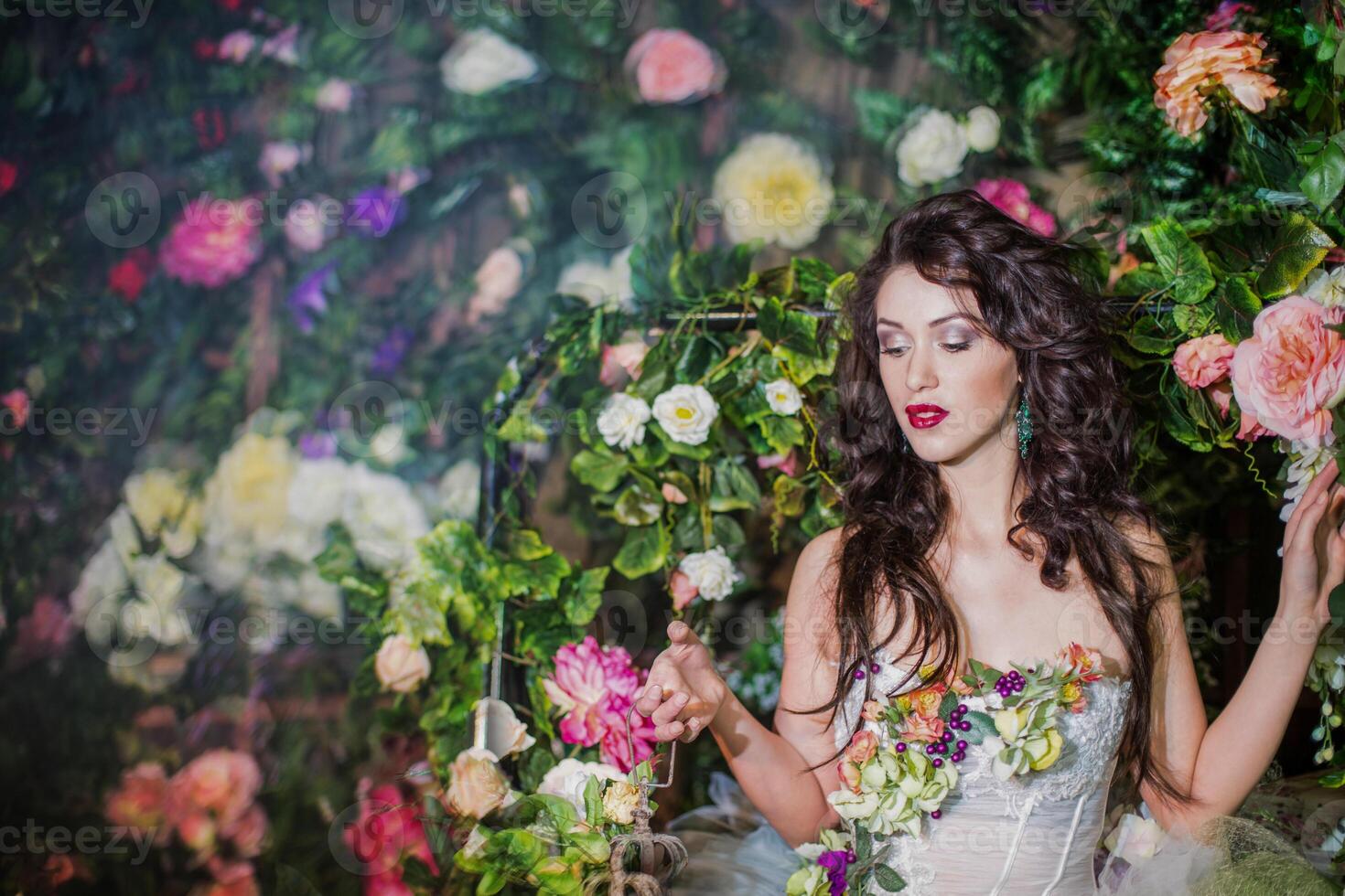 girl in the image of a flower fairy on a background of flowers photo