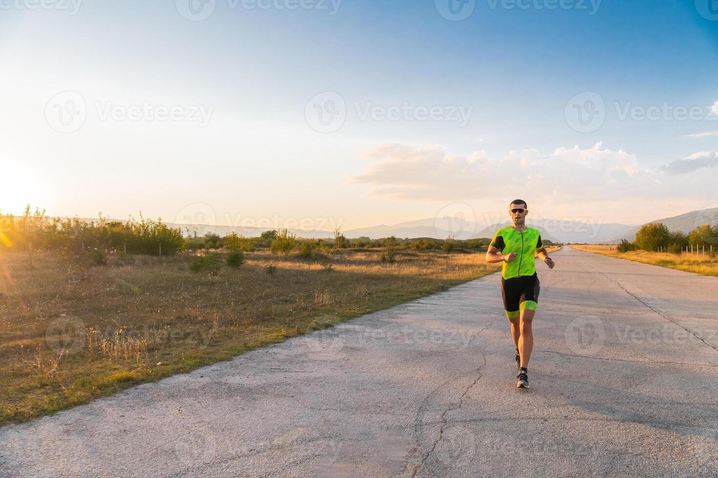 Triathlete in professional gear running early in the morning, preparing for a marathon, dedication to sport and readiness to take on the challenges of a marathon. photo