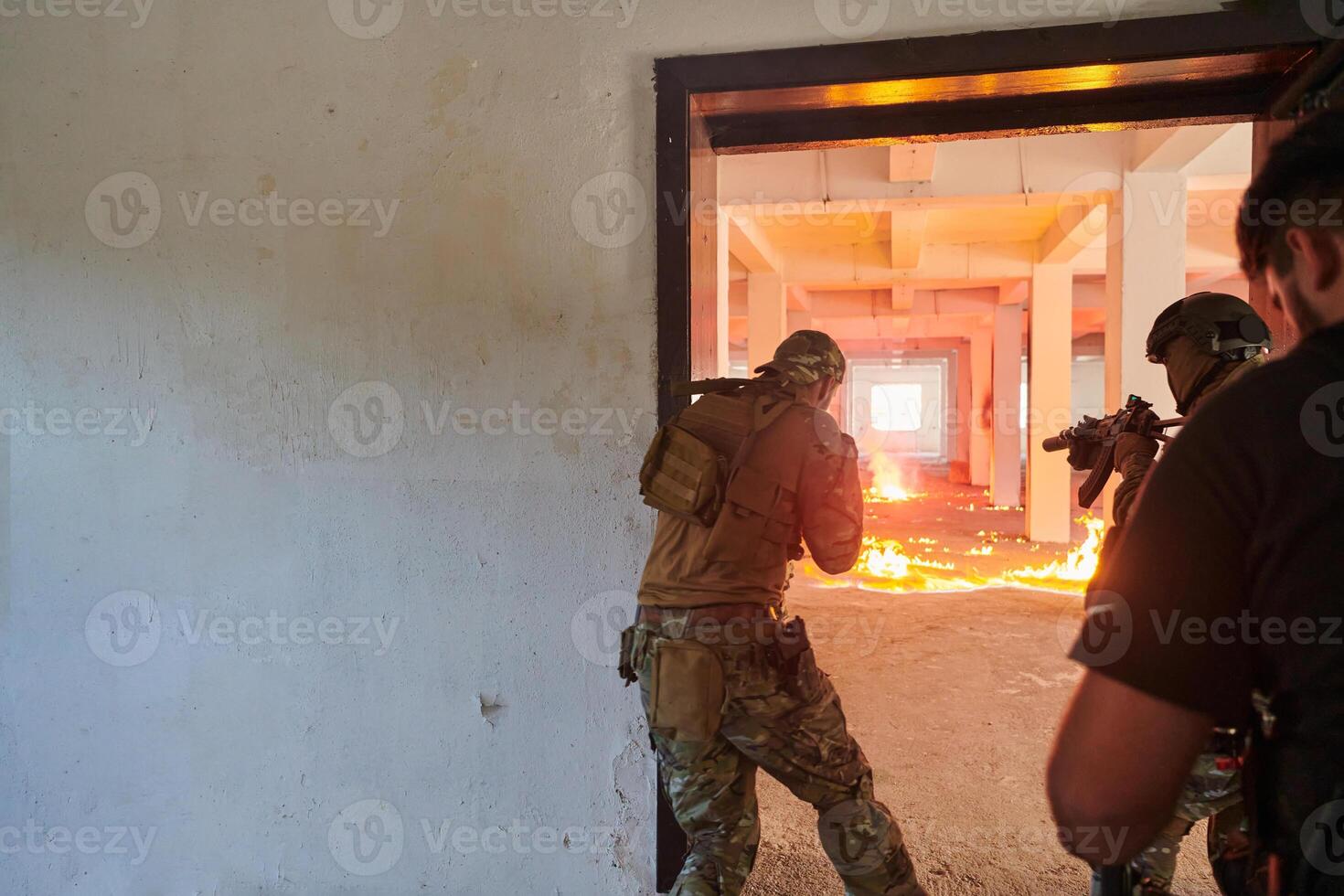 A group of professional soldiers bravely executes a dangerous rescue mission, surrounded by fire in a perilous building. photo