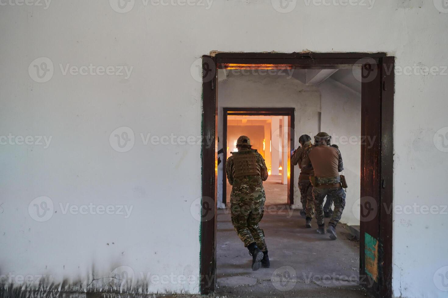 A group of professional soldiers bravely executes a dangerous rescue mission, surrounded by fire in a perilous building. photo