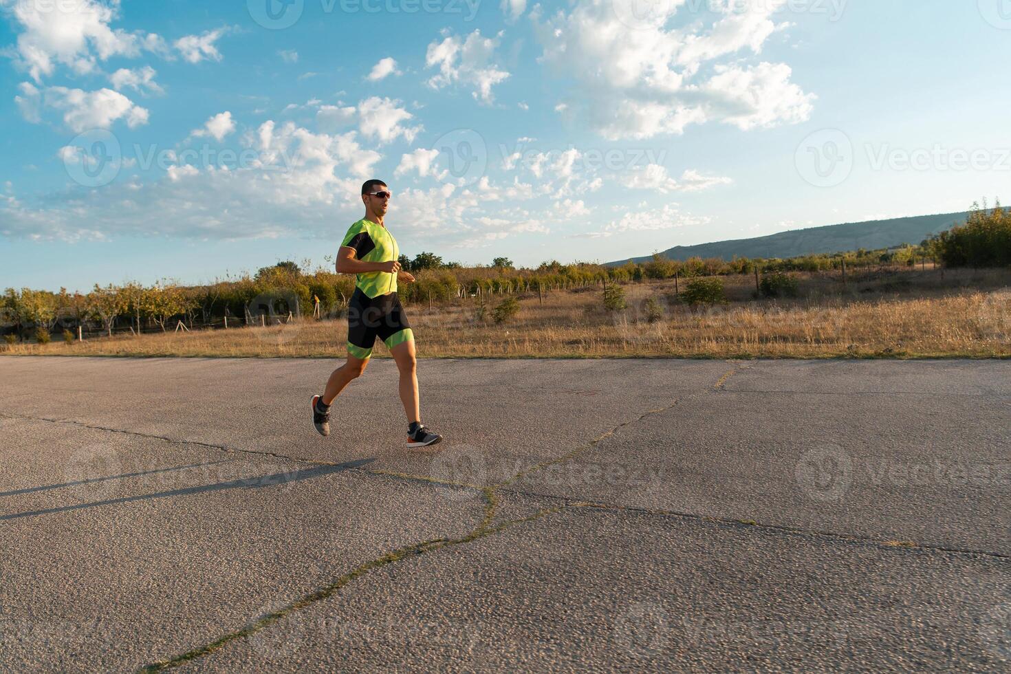 Triathlete in professional gear running early in the morning, preparing for a marathon, dedication to sport and readiness to take on the challenges of a marathon. photo