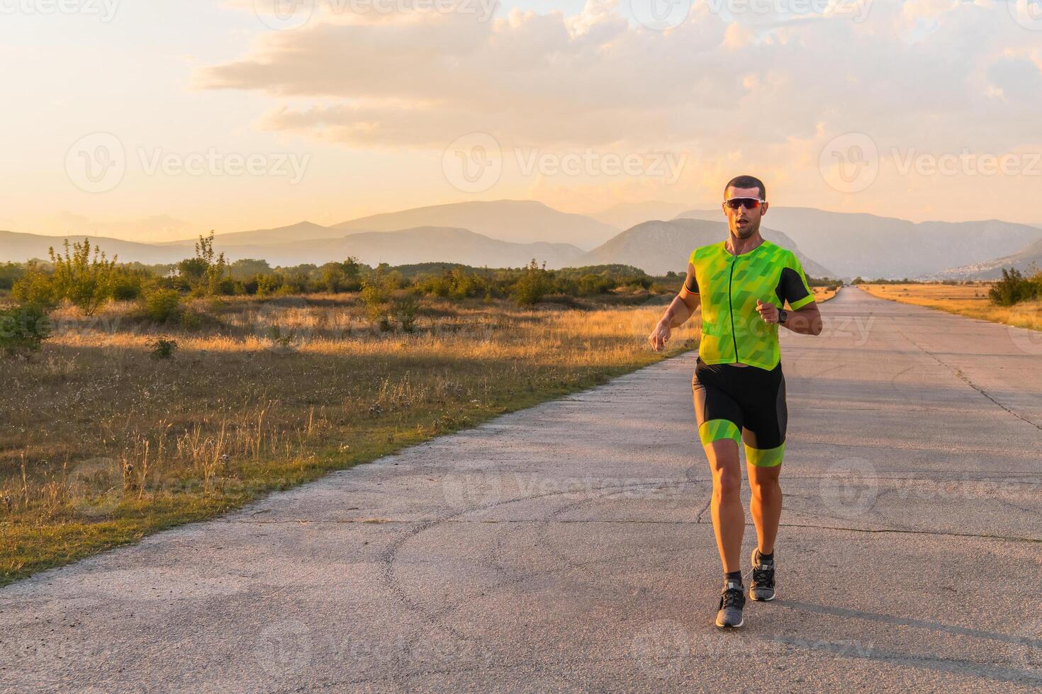 Triathlete in professional gear running early in the morning, preparing for a marathon, dedication to sport and readiness to take on the challenges of a marathon. photo
