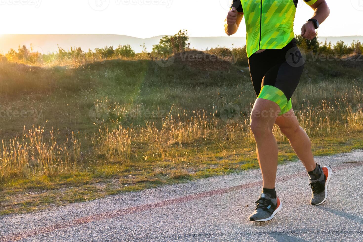 Triathlete in professional gear running early in the morning, preparing for a marathon, dedication to sport and readiness to take on the challenges of a marathon. photo