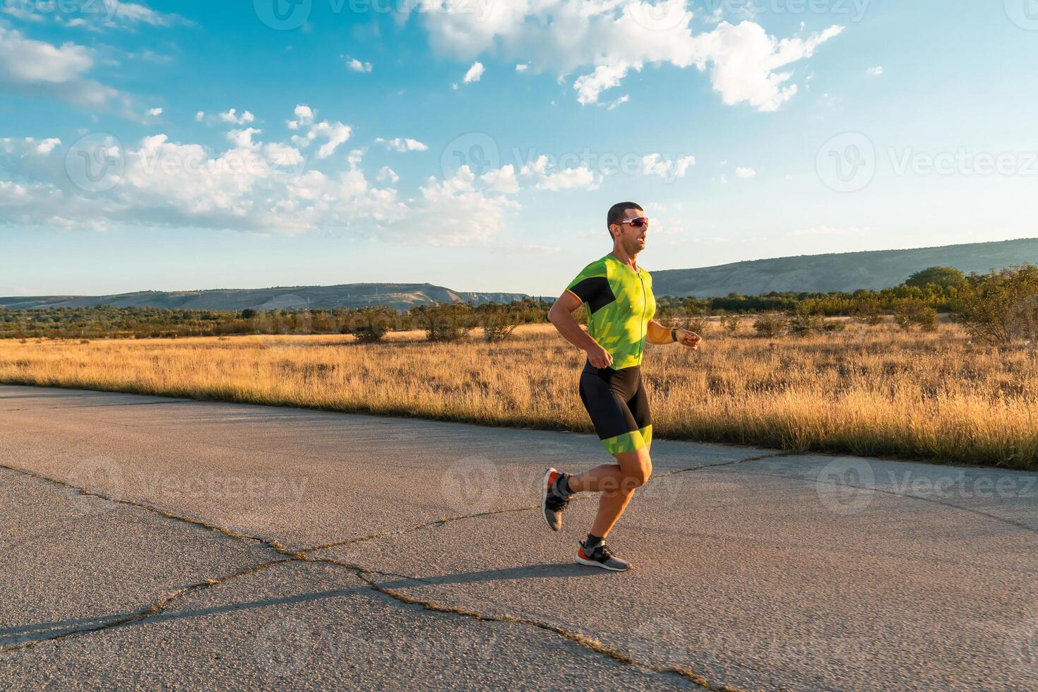 Triathlete in professional gear running early in the morning, preparing for a marathon, dedication to sport and readiness to take on the challenges of a marathon. photo