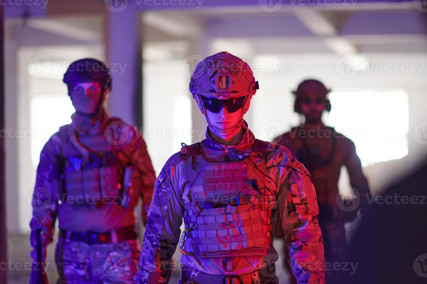 Soldier squad team walking in urban environment colored lightis photo