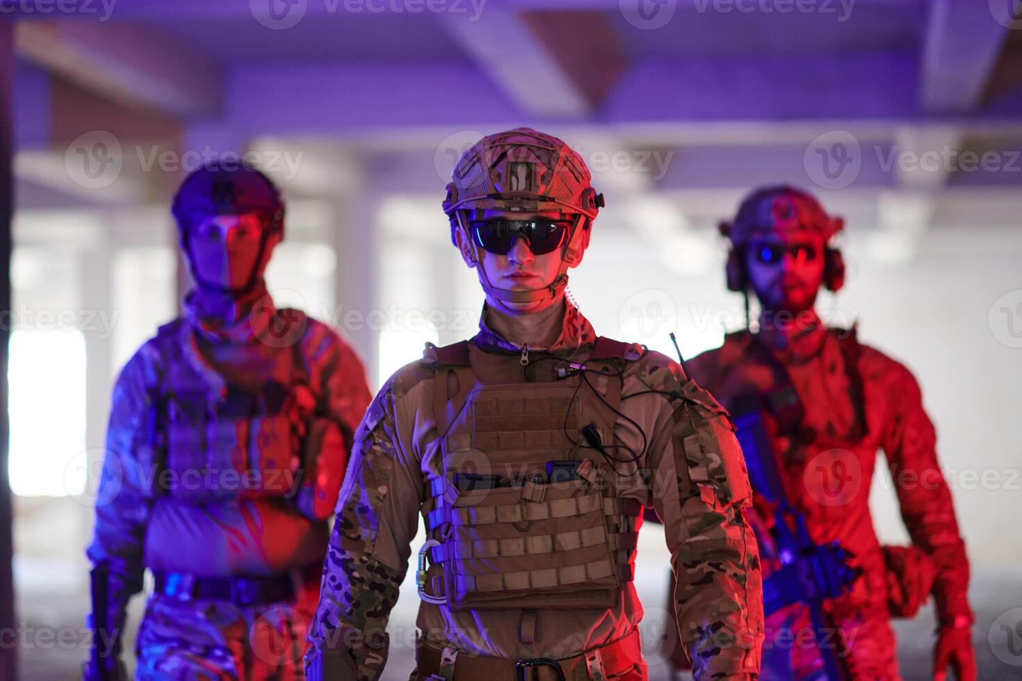 Soldier squad team walking in urban environment colored lightis photo