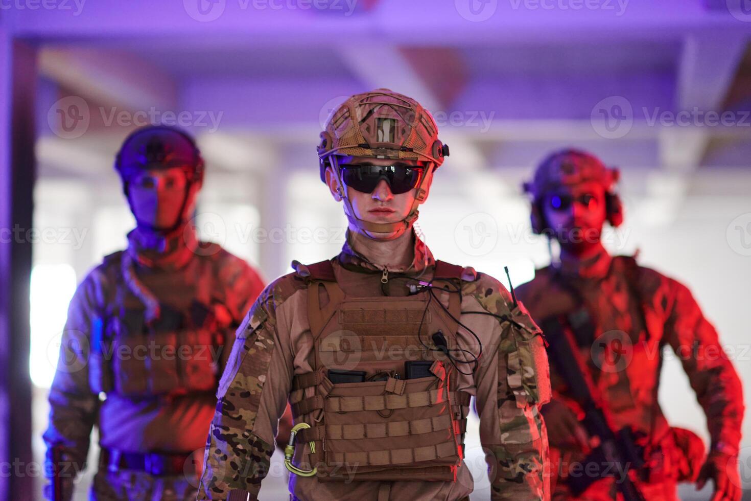 Soldier squad team walking in urban environment colored lightis photo