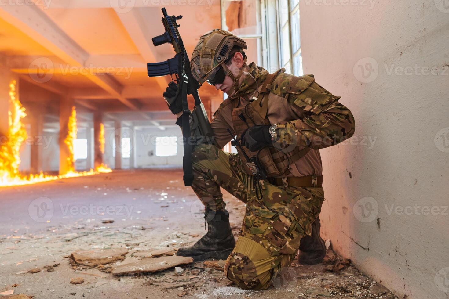 Soldier in action near window changing magazine and take cover photo