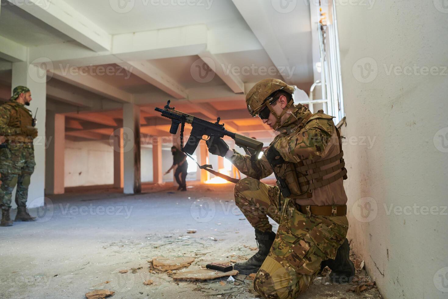 Soldier in action near window changing magazine and take cover photo