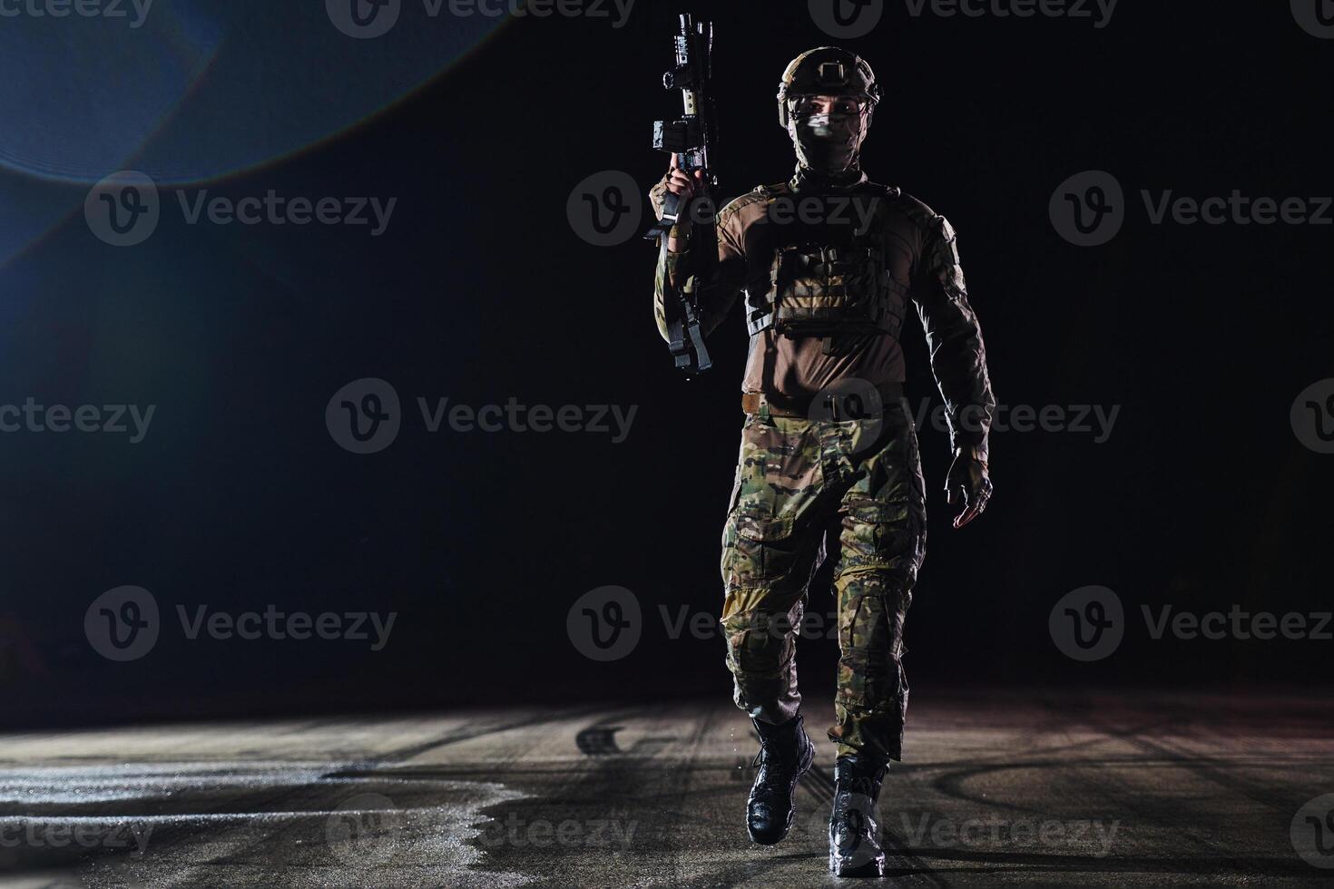 A professional soldier in full military gear striding through the dark night as he embarks on a perilous military mission photo
