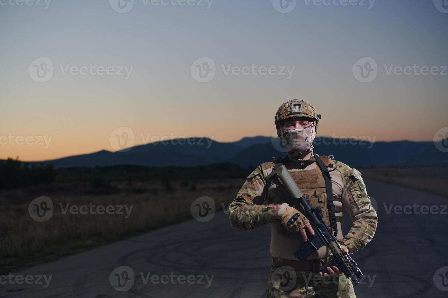 A professional soldier in full military gear striding through the dark night as he embarks on a perilous military mission photo