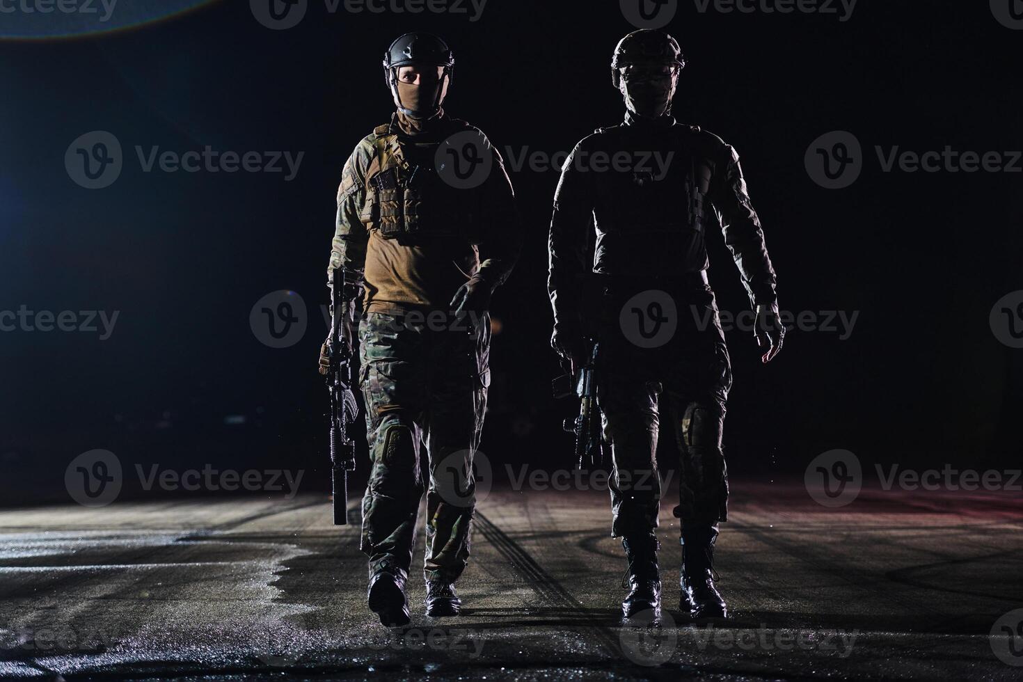 Two professional soldiers marching through the dark of night on a dangerous mission, epitomizing their unwavering bravery, unwavering teamwork, and the high-stakes intensity of their specialized photo