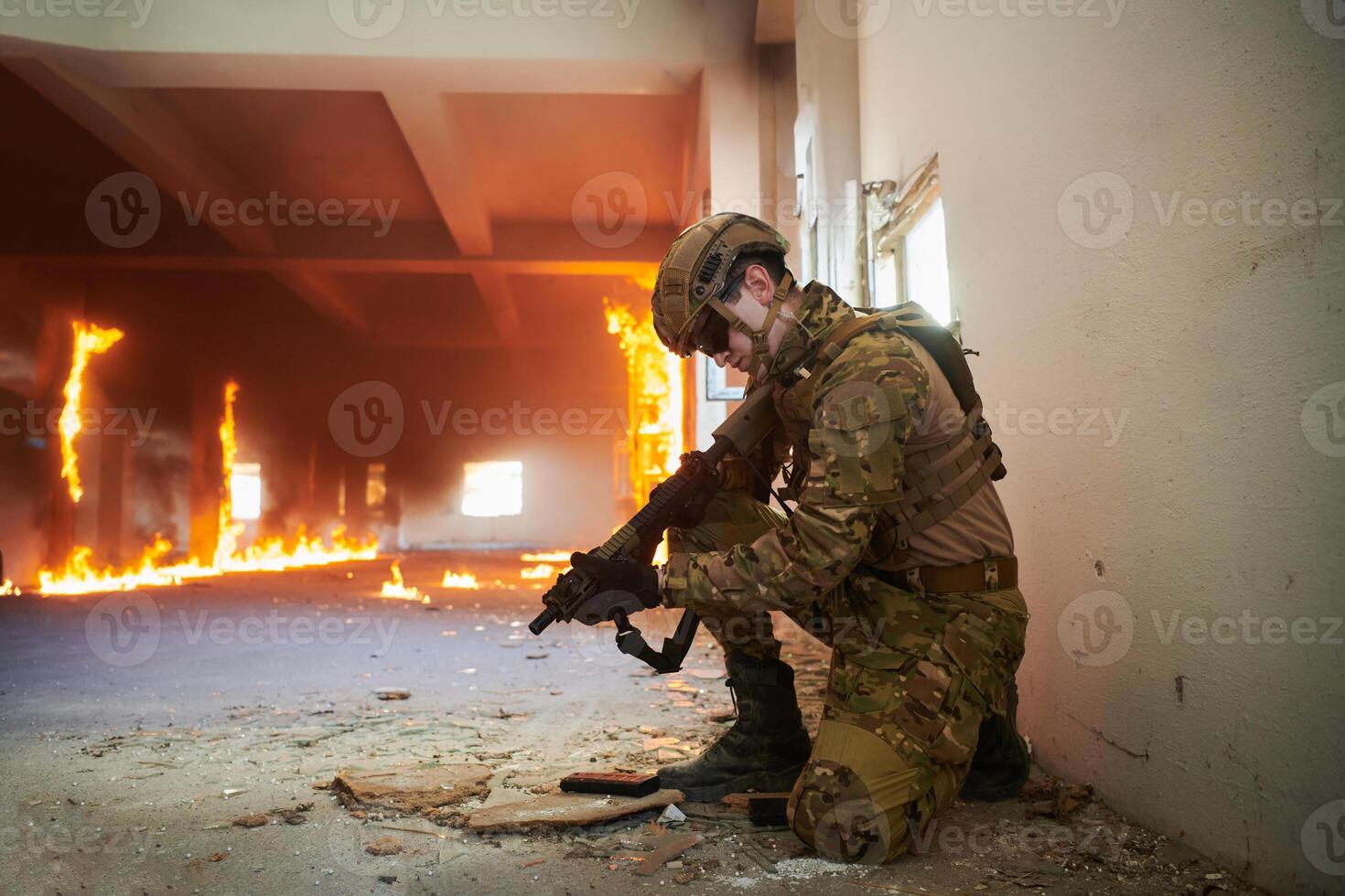 Soldier in action near window changing magazine and take cover photo