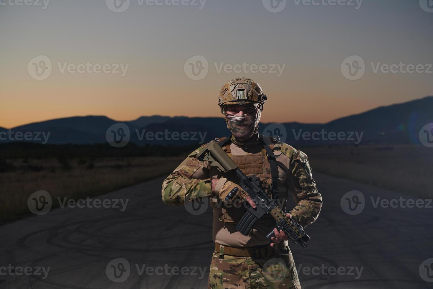 A professional soldier in full military gear striding through the dark night as he embarks on a perilous military mission photo