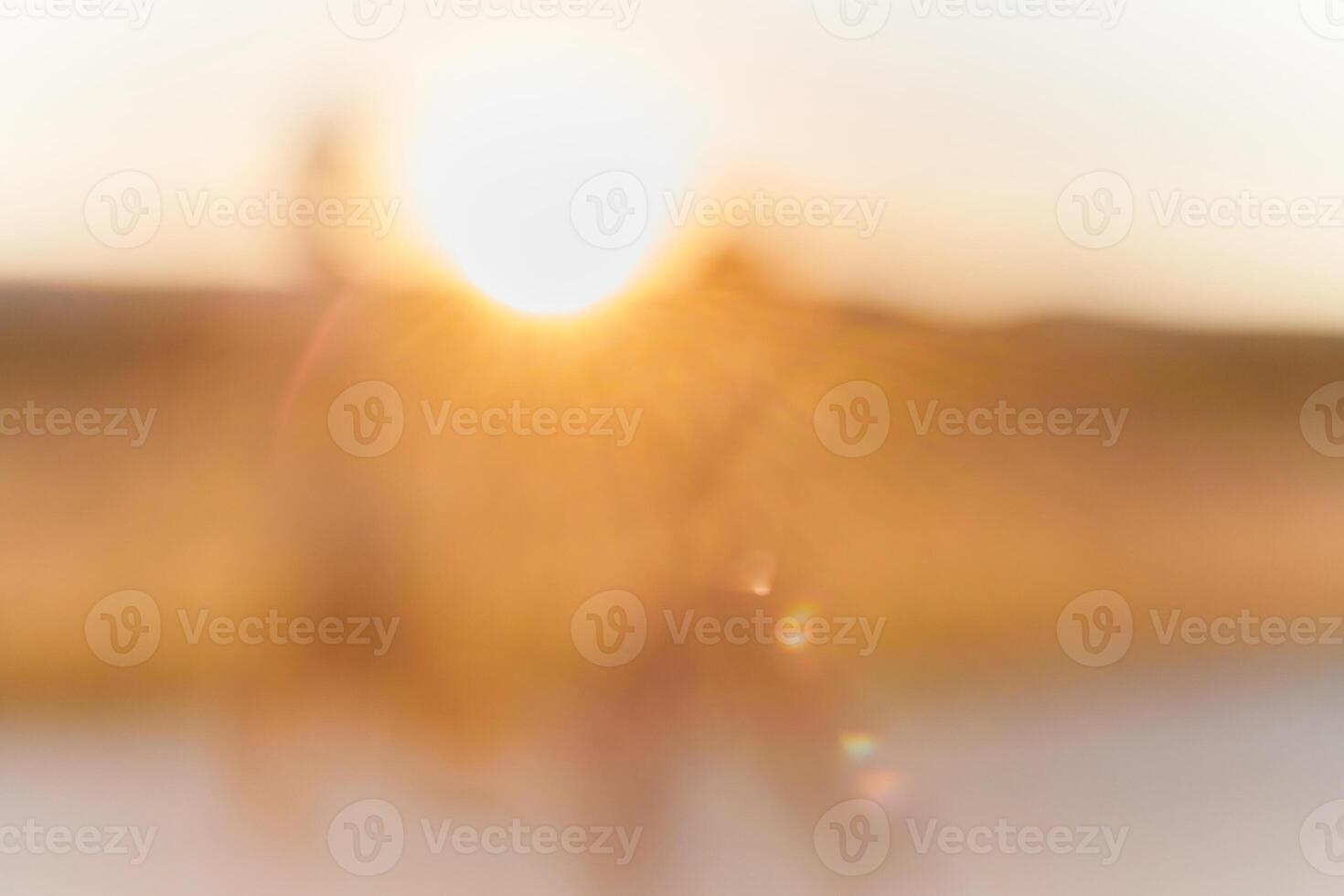 The mesmerizing beauty of a hazy sunrise, as the early morning mist diffuses the golden rays of light, creating an ethereal and enchanting landscape that evokes a sense of tranquility and serenity. photo