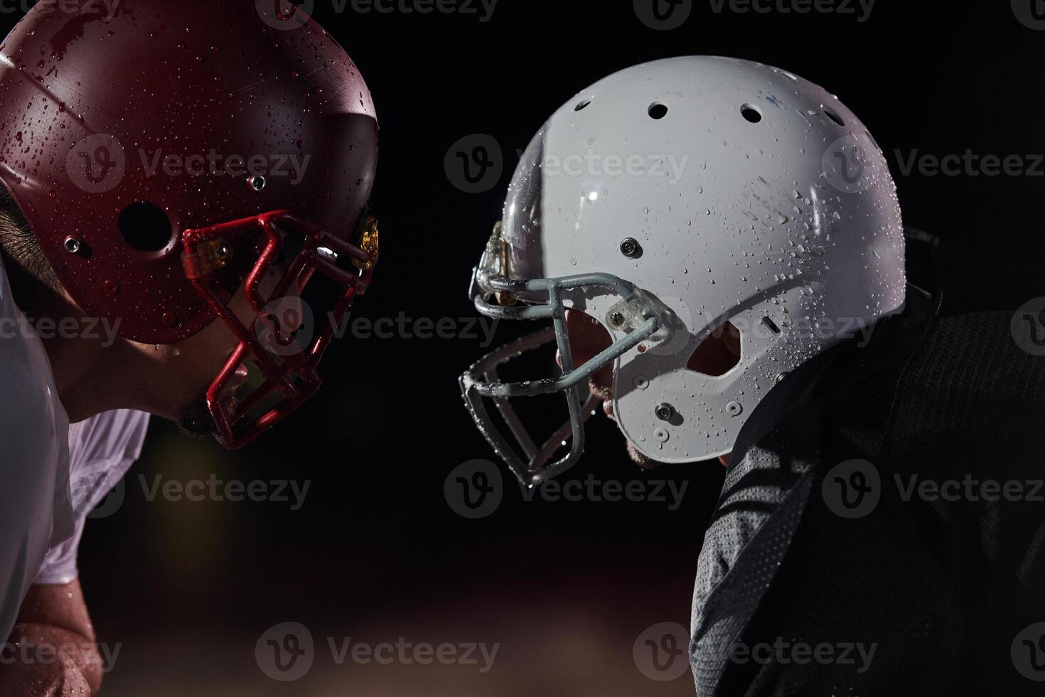 Two american football players face to face in silhouette shadow on white background photo