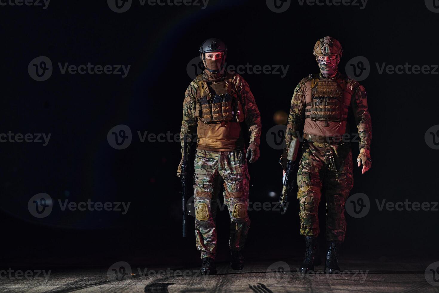 Two professional soldiers marching through the dark of night on a dangerous mission, epitomizing their unwavering bravery, unwavering teamwork, and the high-stakes intensity of their specialized photo