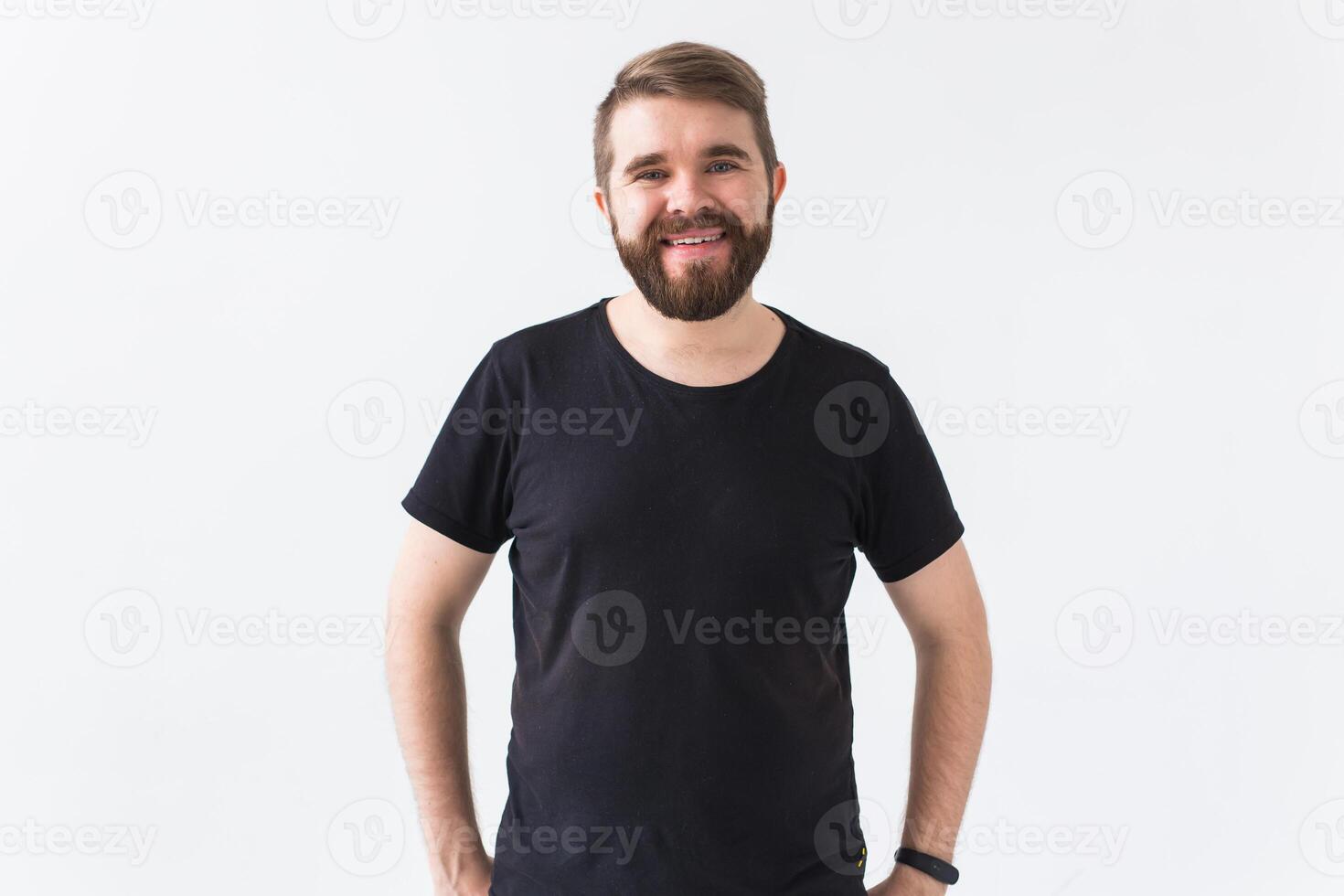 Cheerful guy smiled happily, has excited expression over white studio background. Holidays, youth, emotions concept. photo