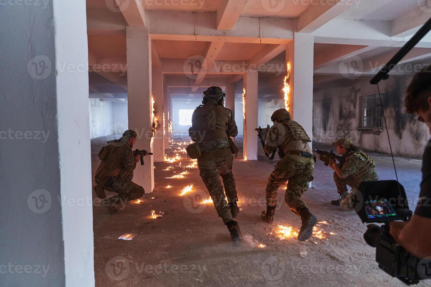A professional cameraman captures the intense moments as a group of skilled soldiers embarks on a dangerous mission inside an abandoned building, their actions filled with suspense and bravery photo