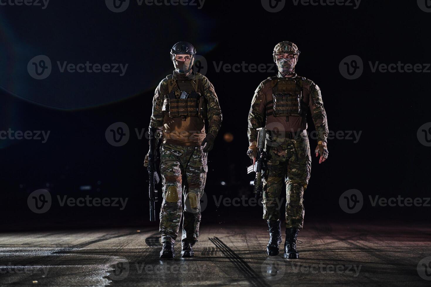 Two professional soldiers marching through the dark of night on a dangerous mission, epitomizing their unwavering bravery, unwavering teamwork, and the high-stakes intensity of their specialized photo