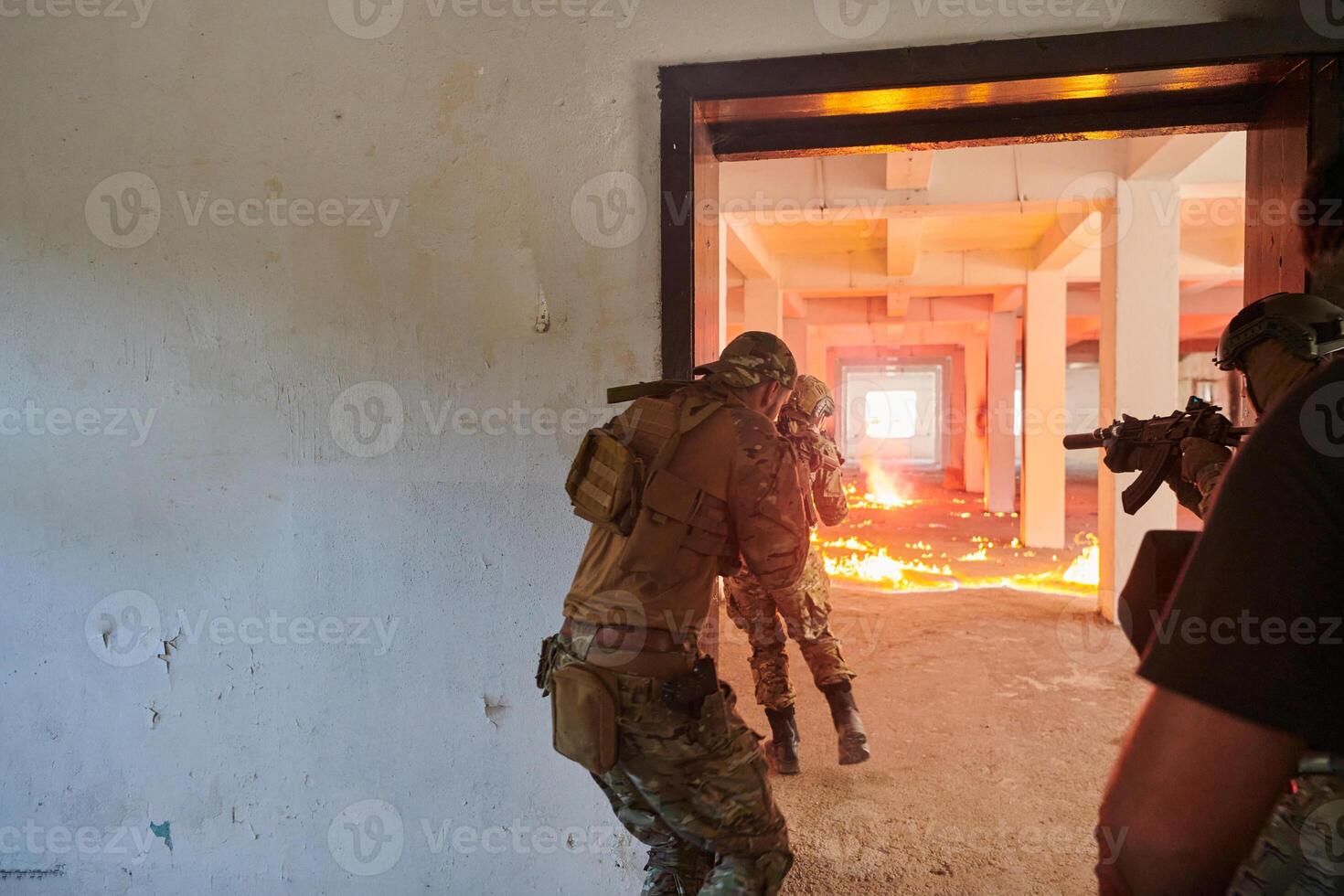 A group of professional soldiers bravely executes a dangerous rescue mission, surrounded by fire in a perilous building. photo