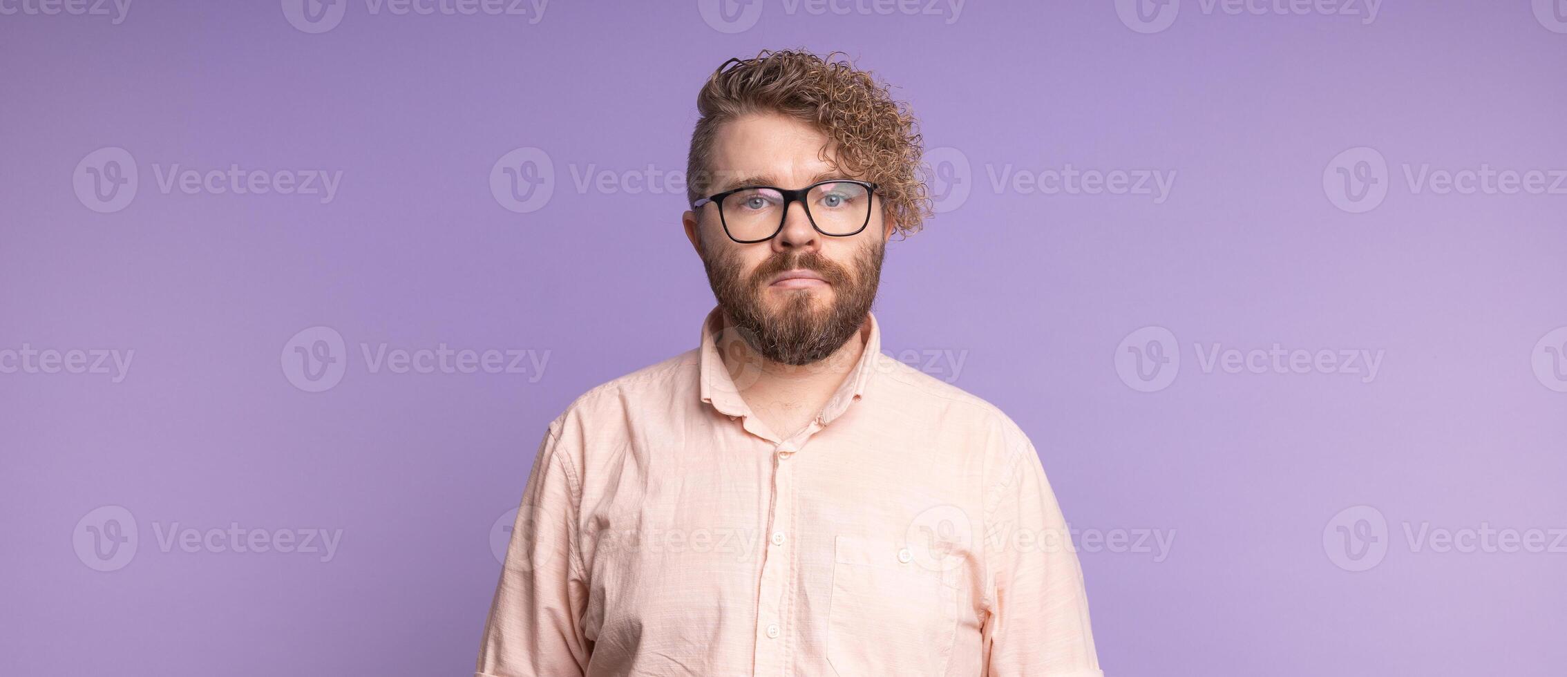 Banner portrait man standing confidently against violet background, copy space. Individuality, modern masculinity, and quiet self-assurance in contemporary portraiture. photo