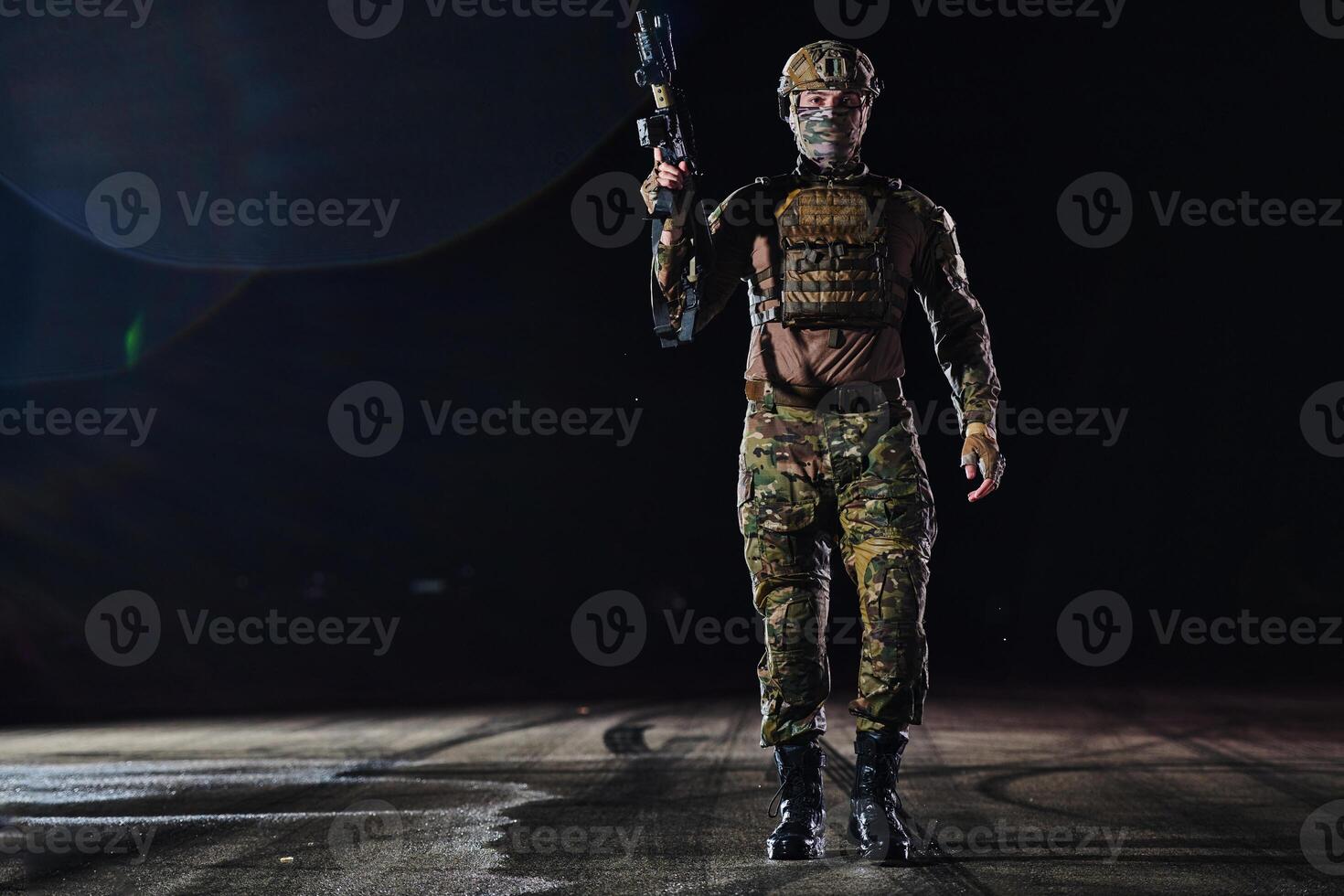 A professional soldier in full military gear striding through the dark night as he embarks on a perilous military mission photo
