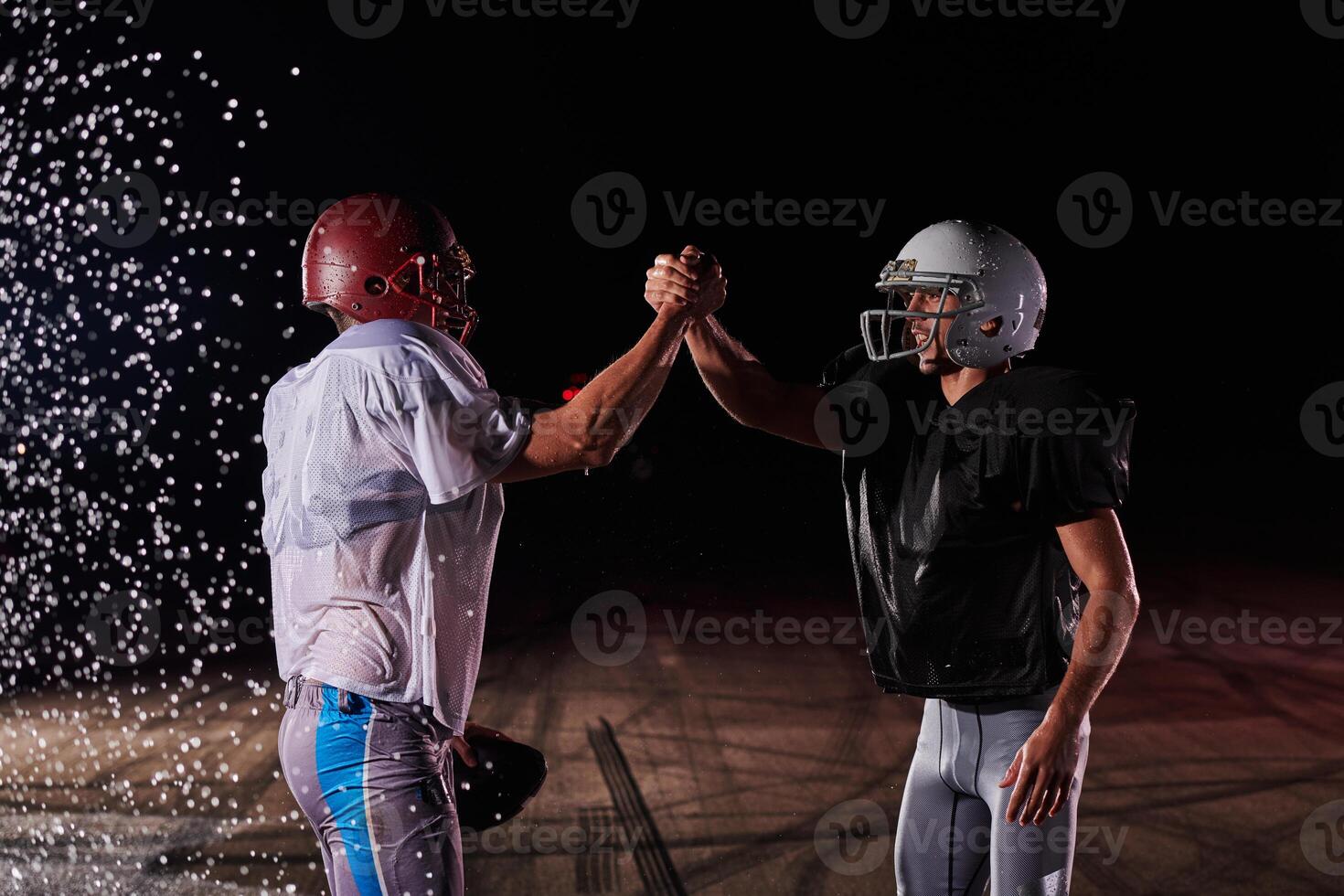 Two american football players face to face in silhouette shadow on white background photo