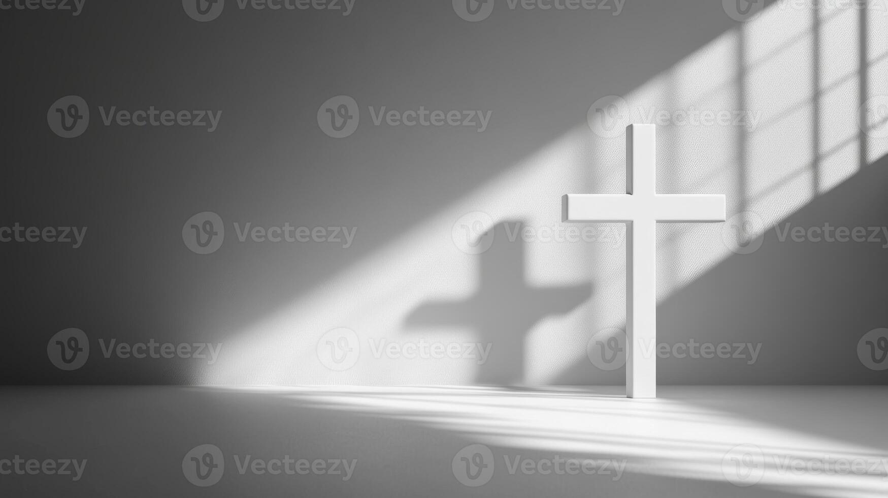 Shadow of cross on white background with sunlight beam cast in grayscale photo
