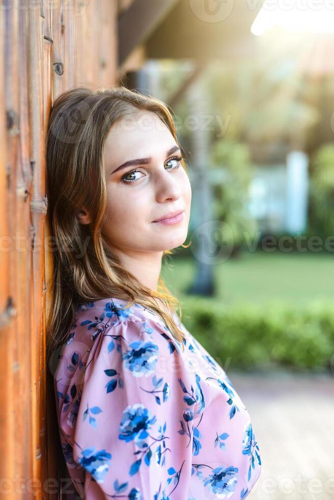Portrait of beautiful Belarusian woman half Ukrainian in pink dress looking photo