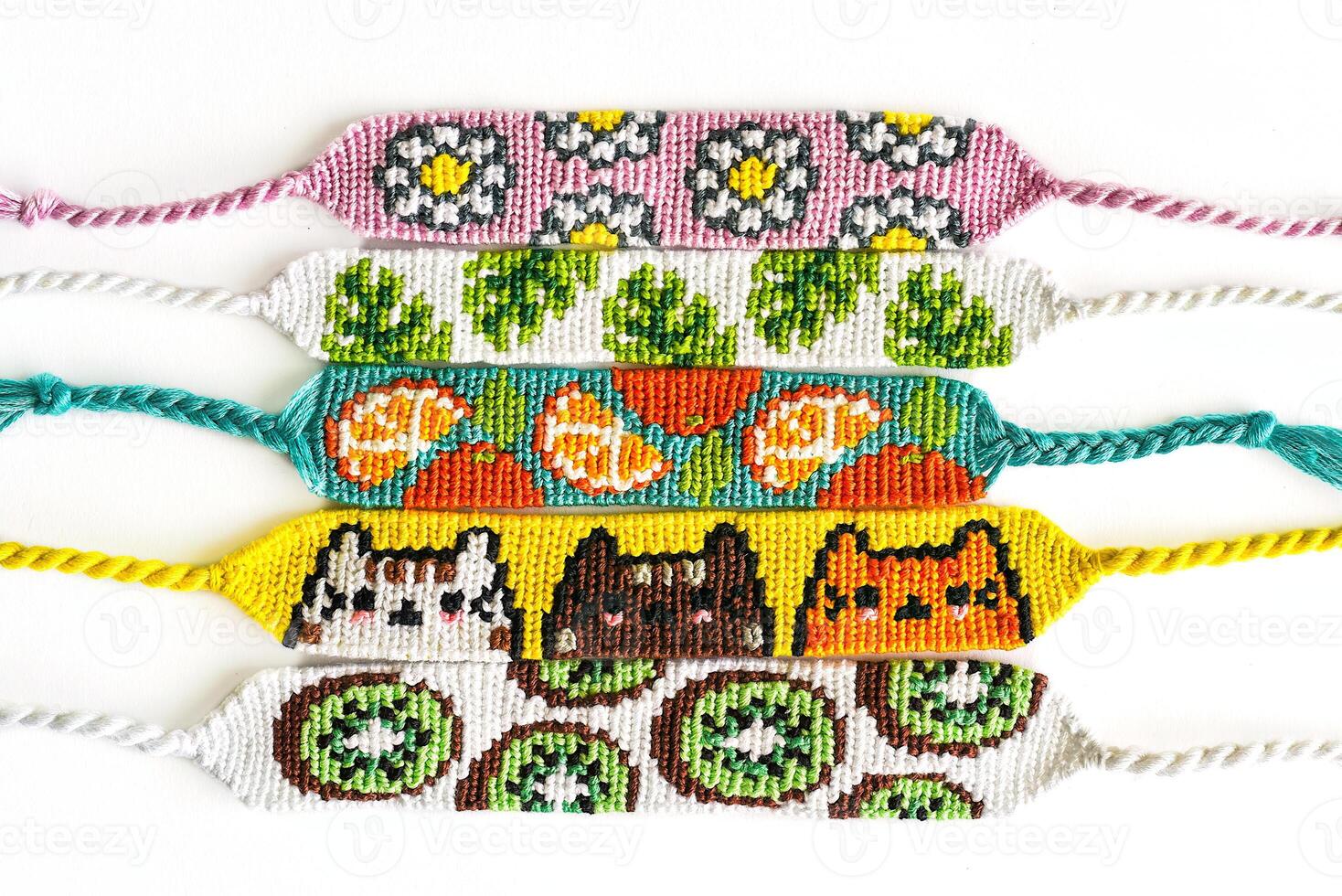 Woven DIY friendship bracelets handmade of embroidery bright thread with knots isolated on white background. Alpha patterns photo