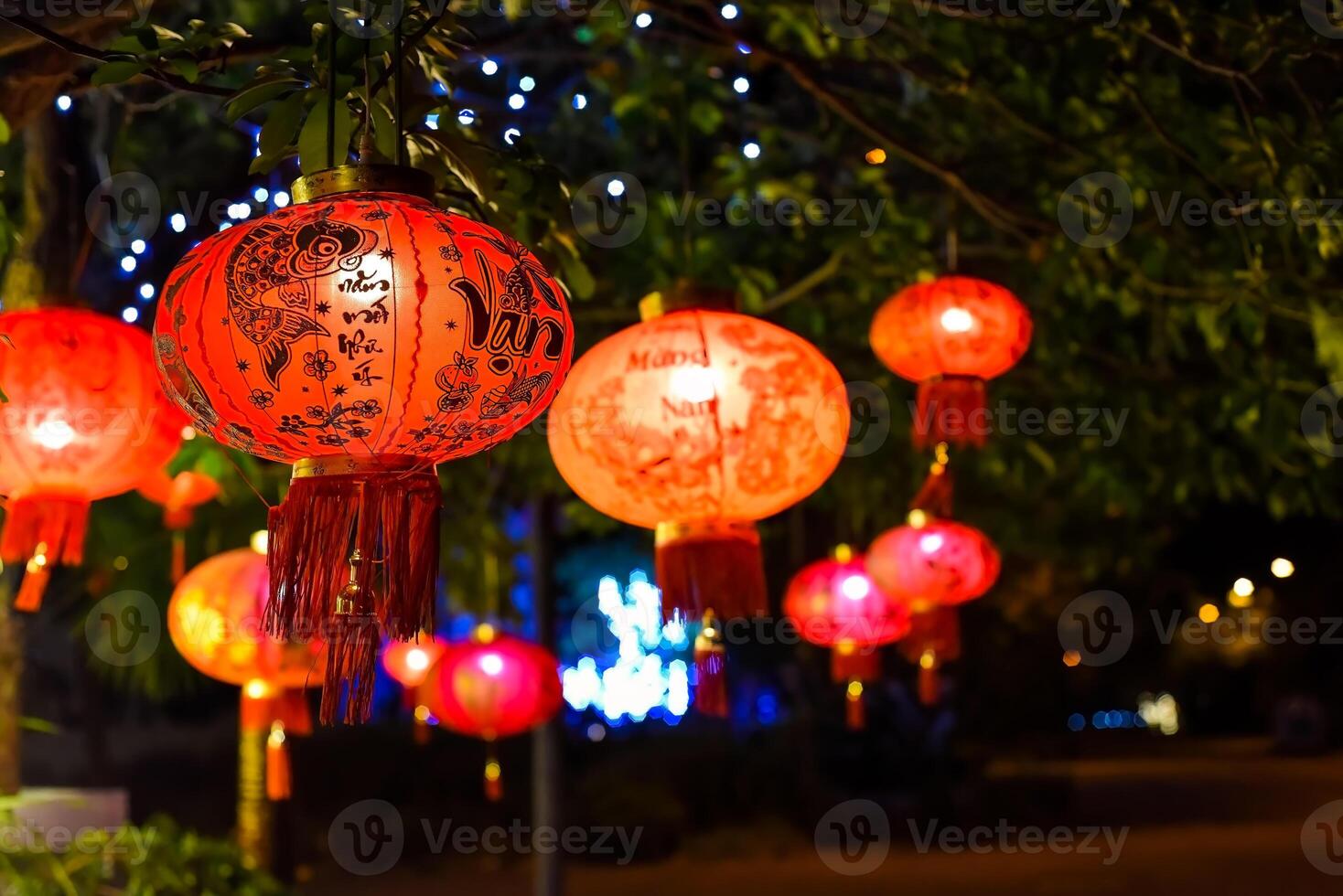 Many red lanterns with vietnamese language translated as Happy New Year hanging in Vietnam for Lunar New Year photo