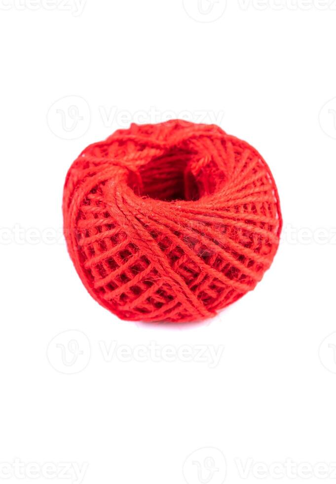 A roll of red jute twine placed on a white background, ideal for crafting, packaging, and DIY projects. Perfect for online stores or product catalogs showcasing eco-friendly materials photo