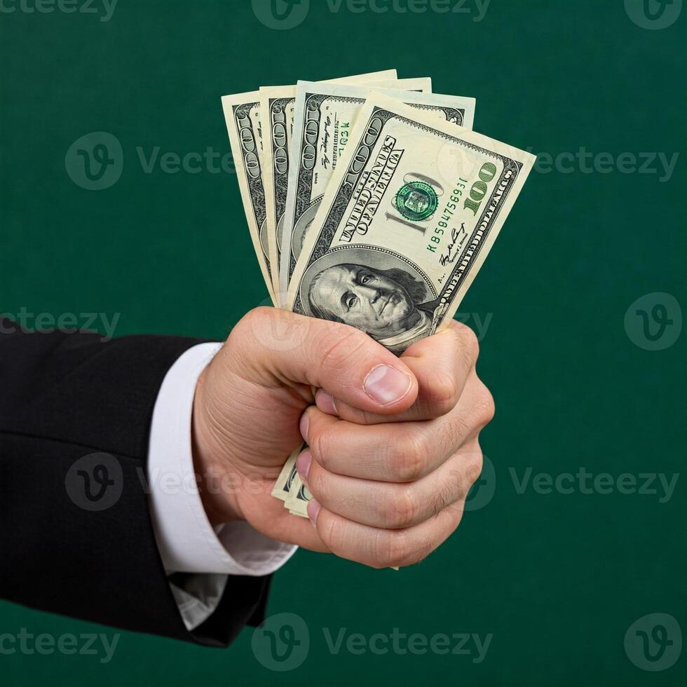 A man in a suit holding a bundle of money photo