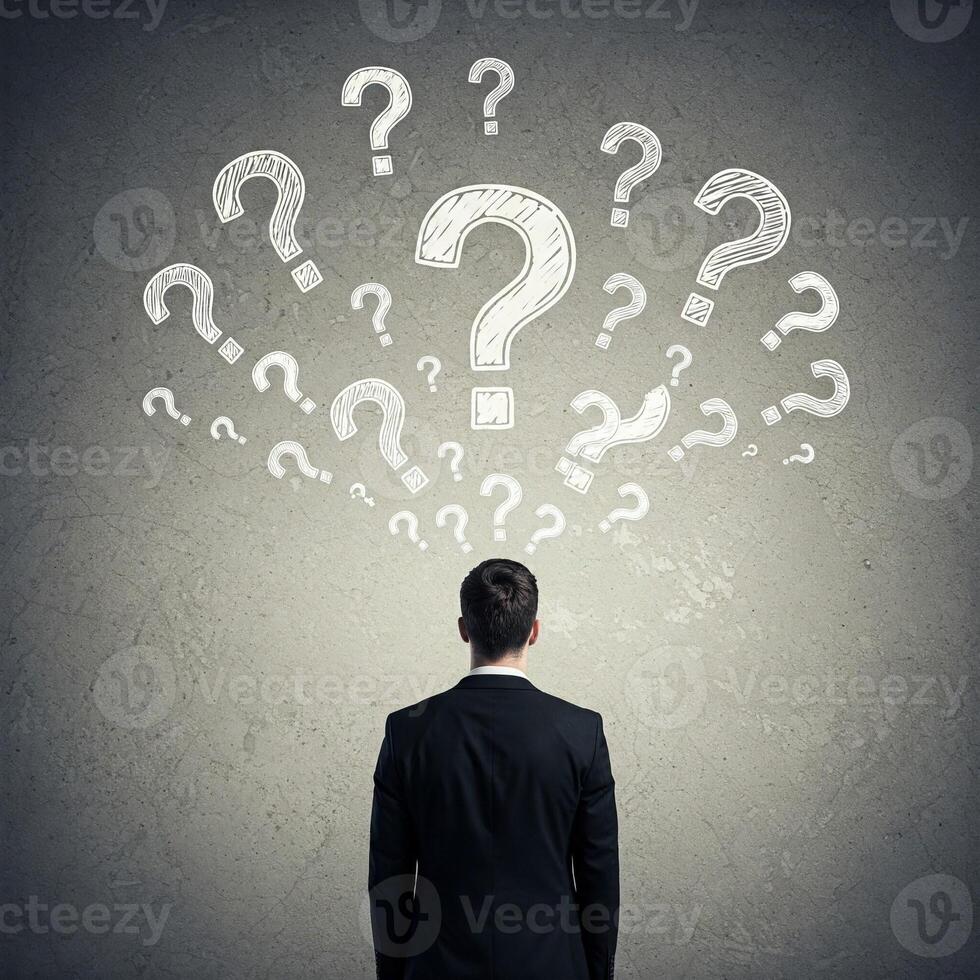 Businessman with question marks on head looking at question marks concept reklamn fot photo